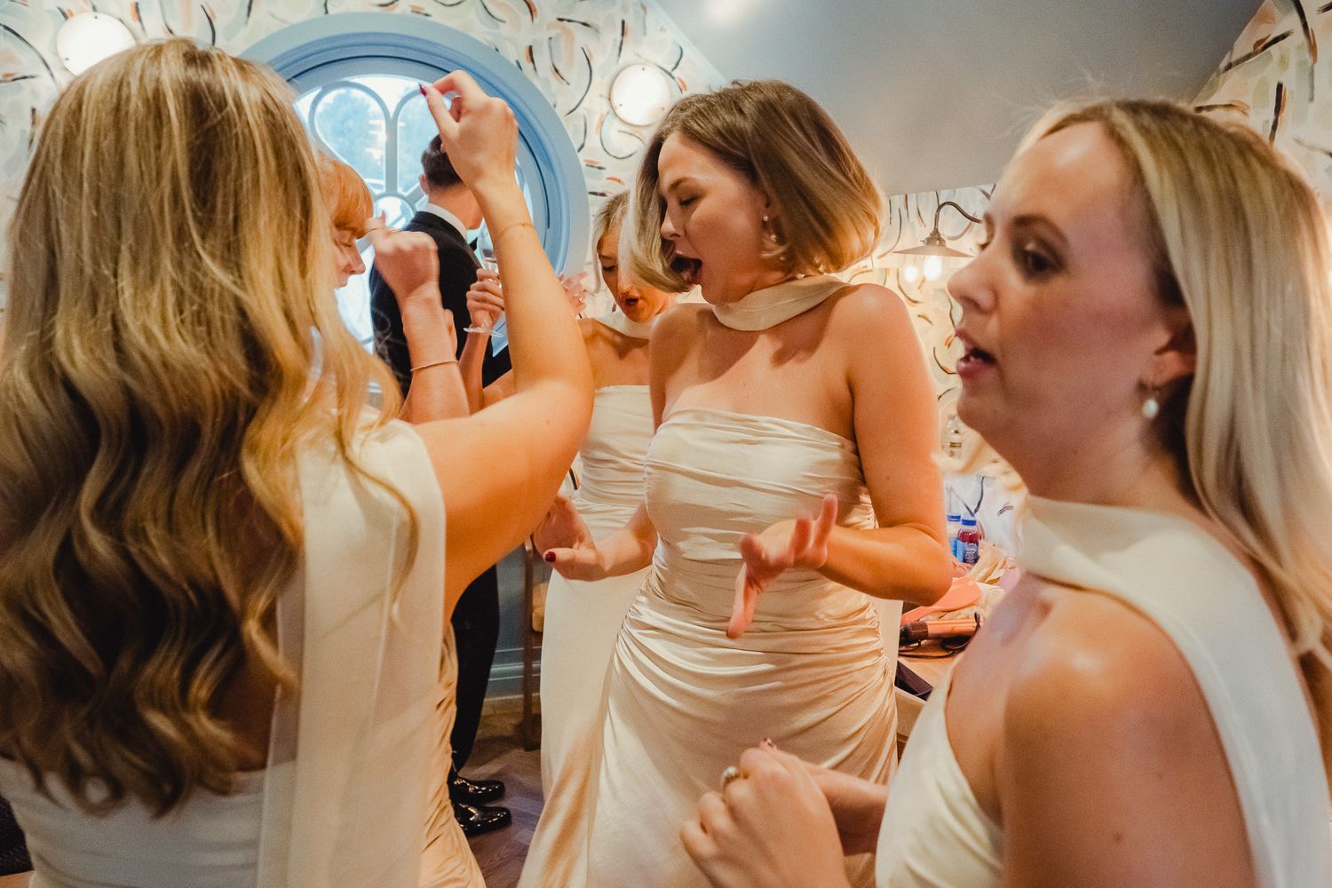 A group of people in formal attire sharing a celebratory drink together at a special event.
