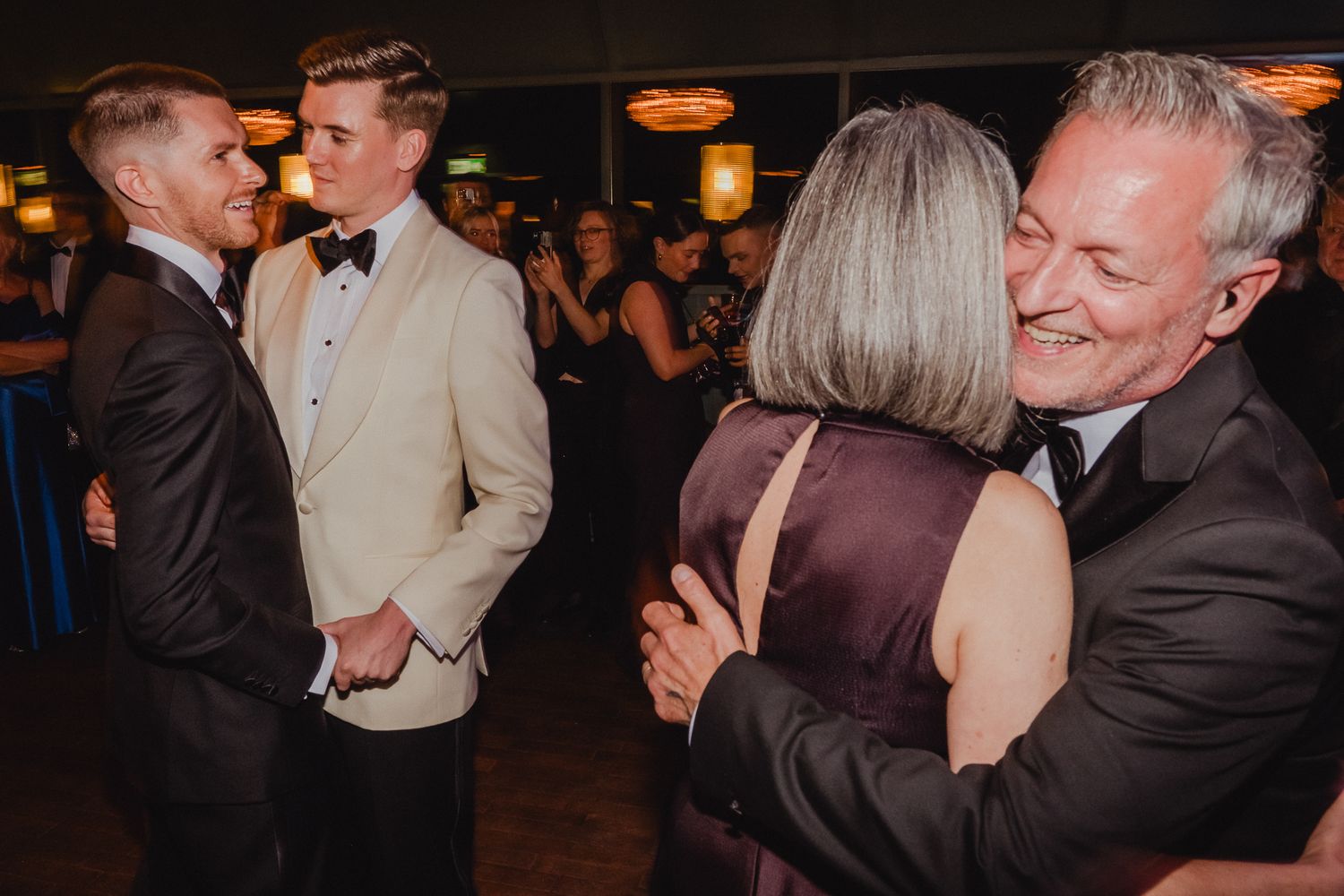 A series of candid dance floor moments captured at a formal evening event with couples dancing together.