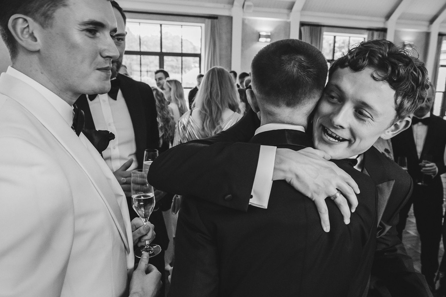 A black and white photo collage shows people dancing and celebrating at what appears to be a wedding reception.
