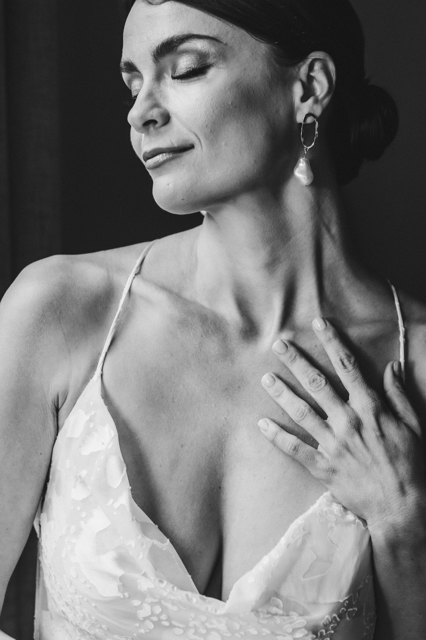 A series of black and white portraits showing elegant poses in a white dress with dramatic lighting.