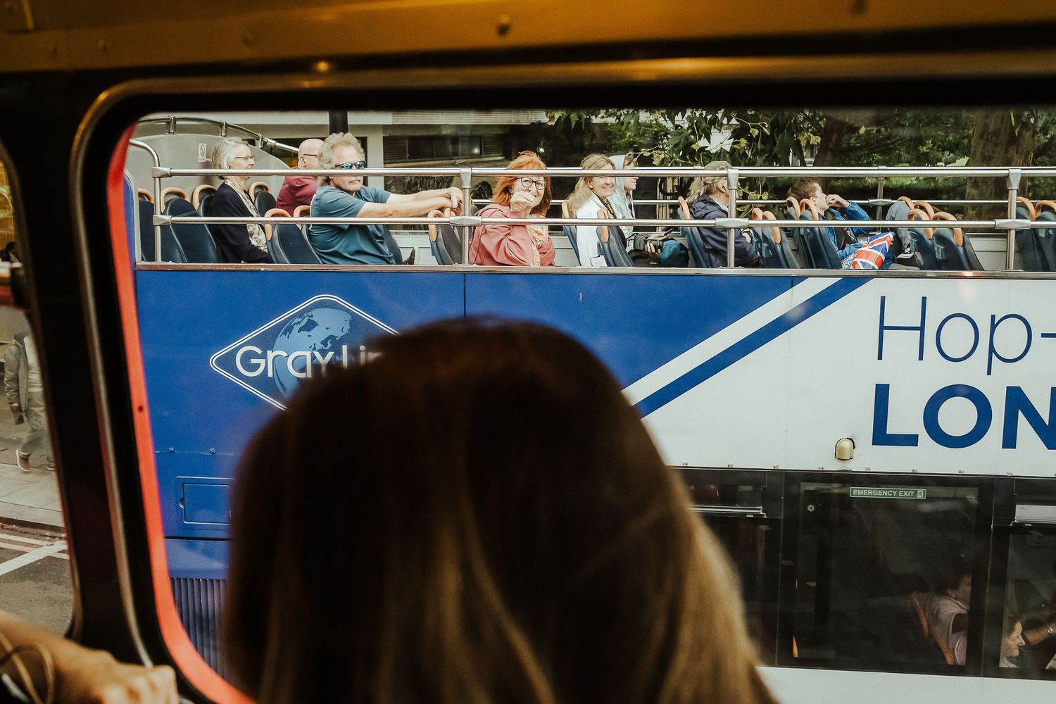 A person wearing a face mask looks out the window of a public transit vehicle during the pandemic.