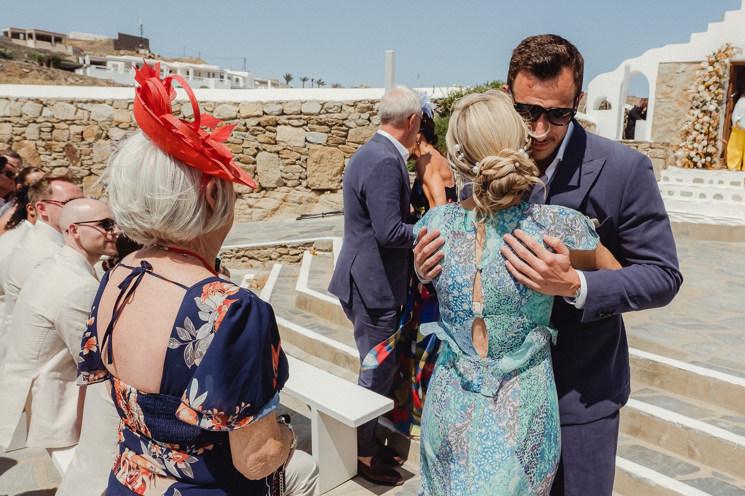 A series of four photos showing tourists visiting ancient stone ruins at an archaeological site on a sunny day.