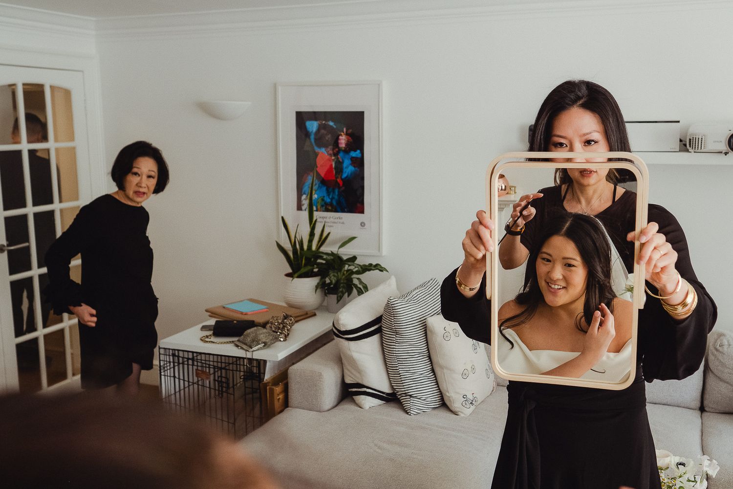 People in a living room having fun with a tablet device creating playful compositions in a modern interior setting.