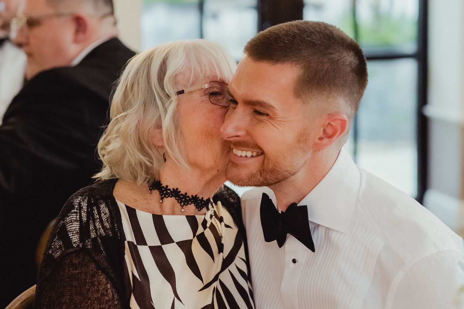 A couple in formal attire shares a joyful moment together during a special celebration.