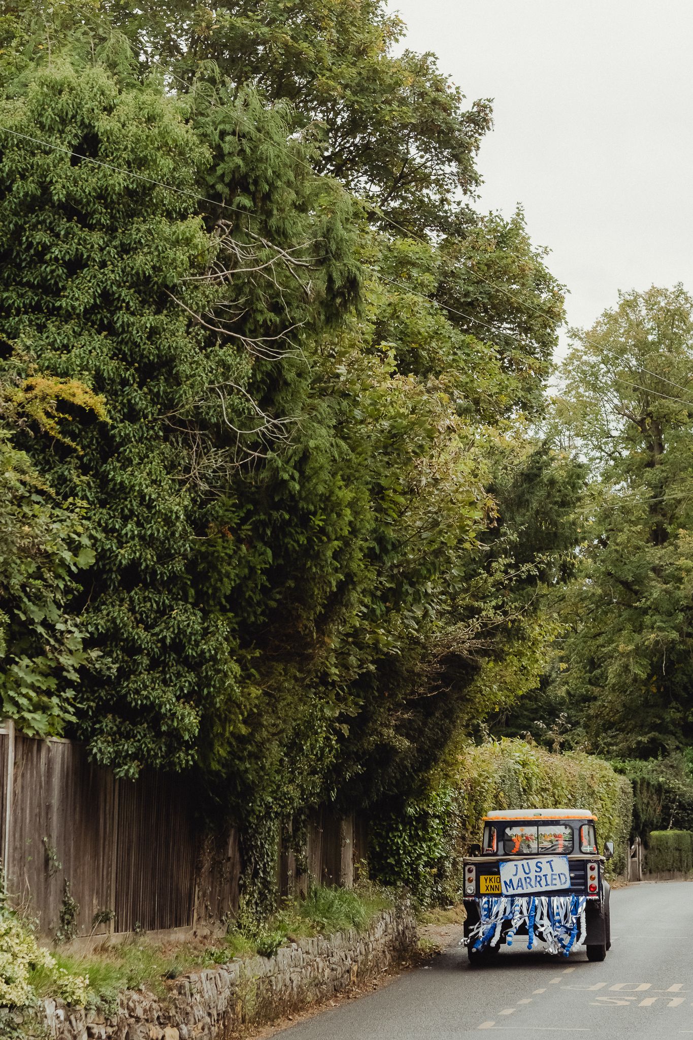 A sequence of photos showing a tree-lined path with wooden fences and a graffiti-covered structure in the distance.