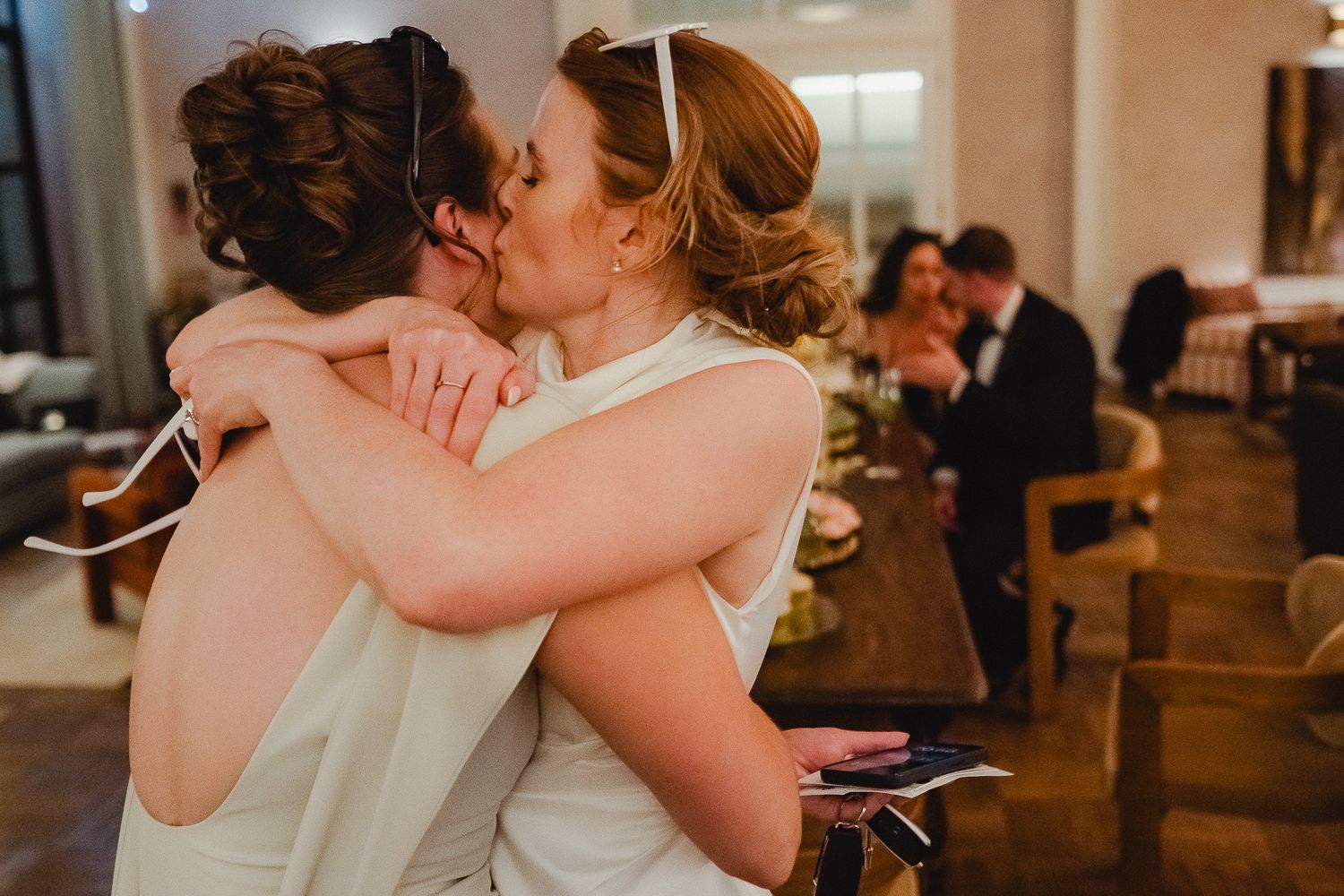 A series of five wedding photos showing emotional embraces and candid moments during a celebration.