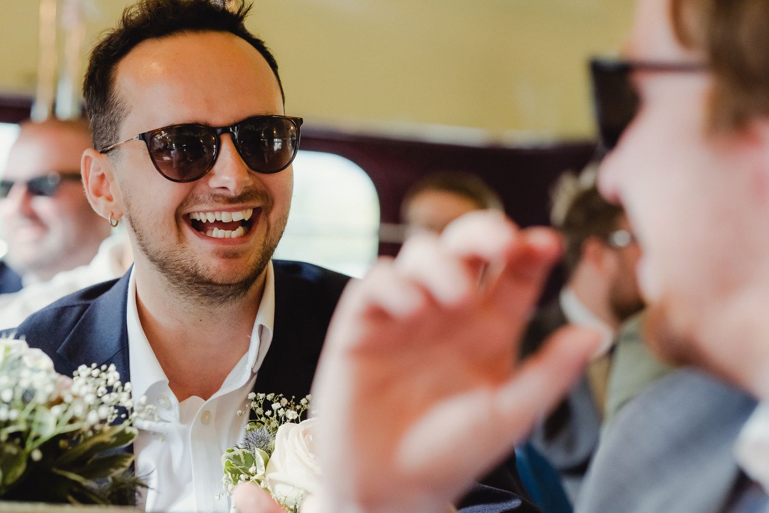 A series of candid reception photos showing guests laughing and socializing at a wedding celebration.