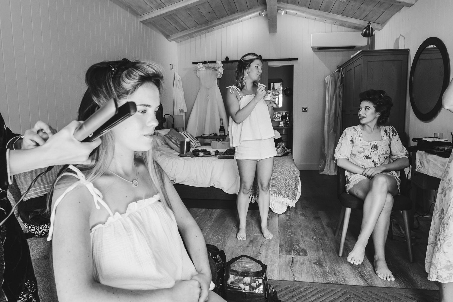 A black and white photo montage showing several scenes of people in a beauty salon getting their hair styled in the 1950s.