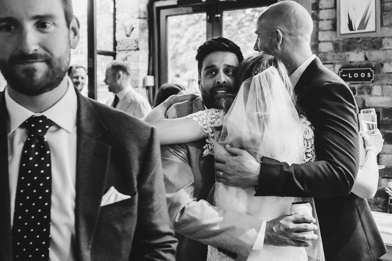 A series of black and white candid photos showing people in formal attire at what appears to be a wedding celebration.