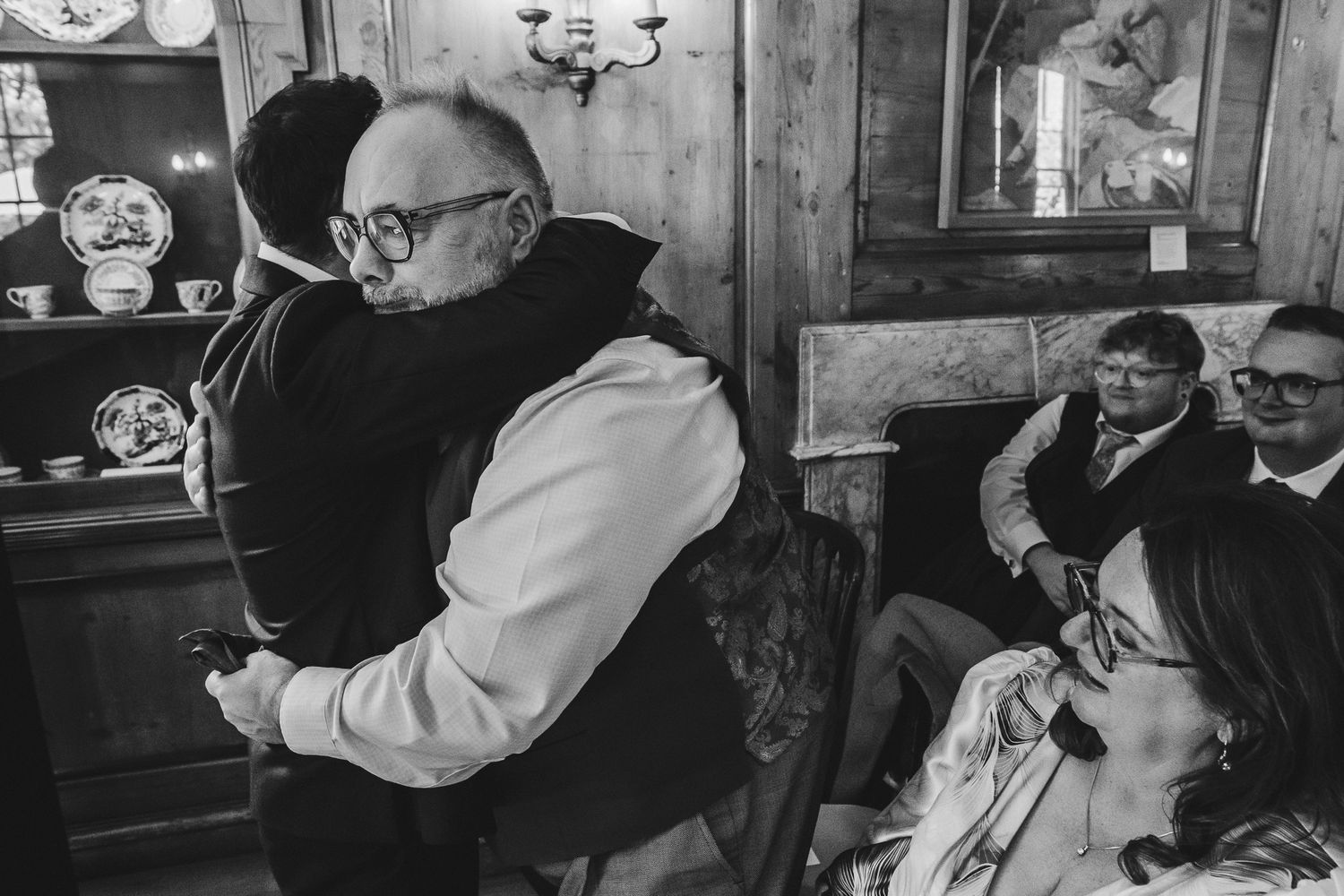 A series of black and white photos showing a couple dancing and embracing in an intimate moment at a wedding celebration.