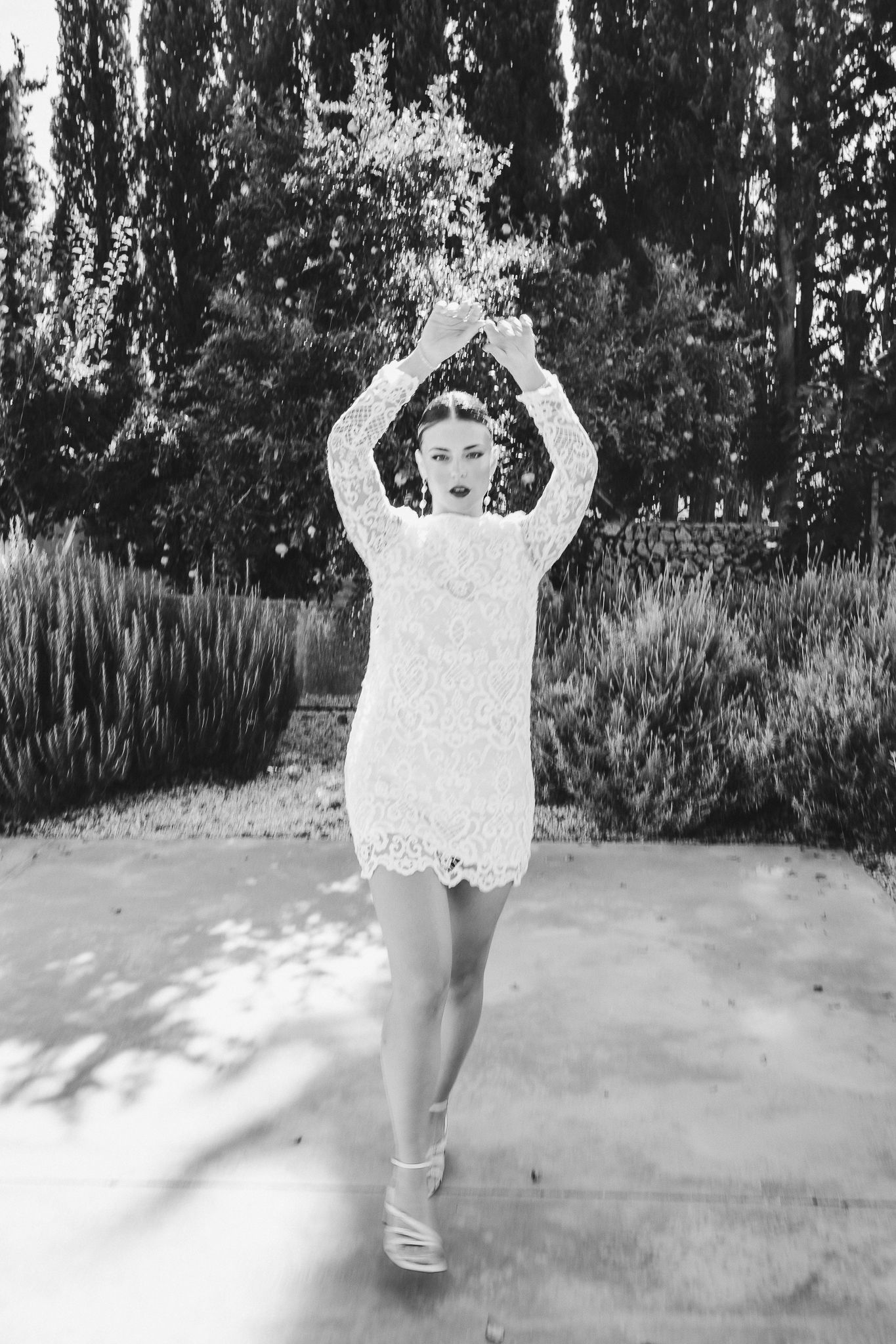 A sequence of four black and white photos showing legs and feet walking in a pattern against a light background.