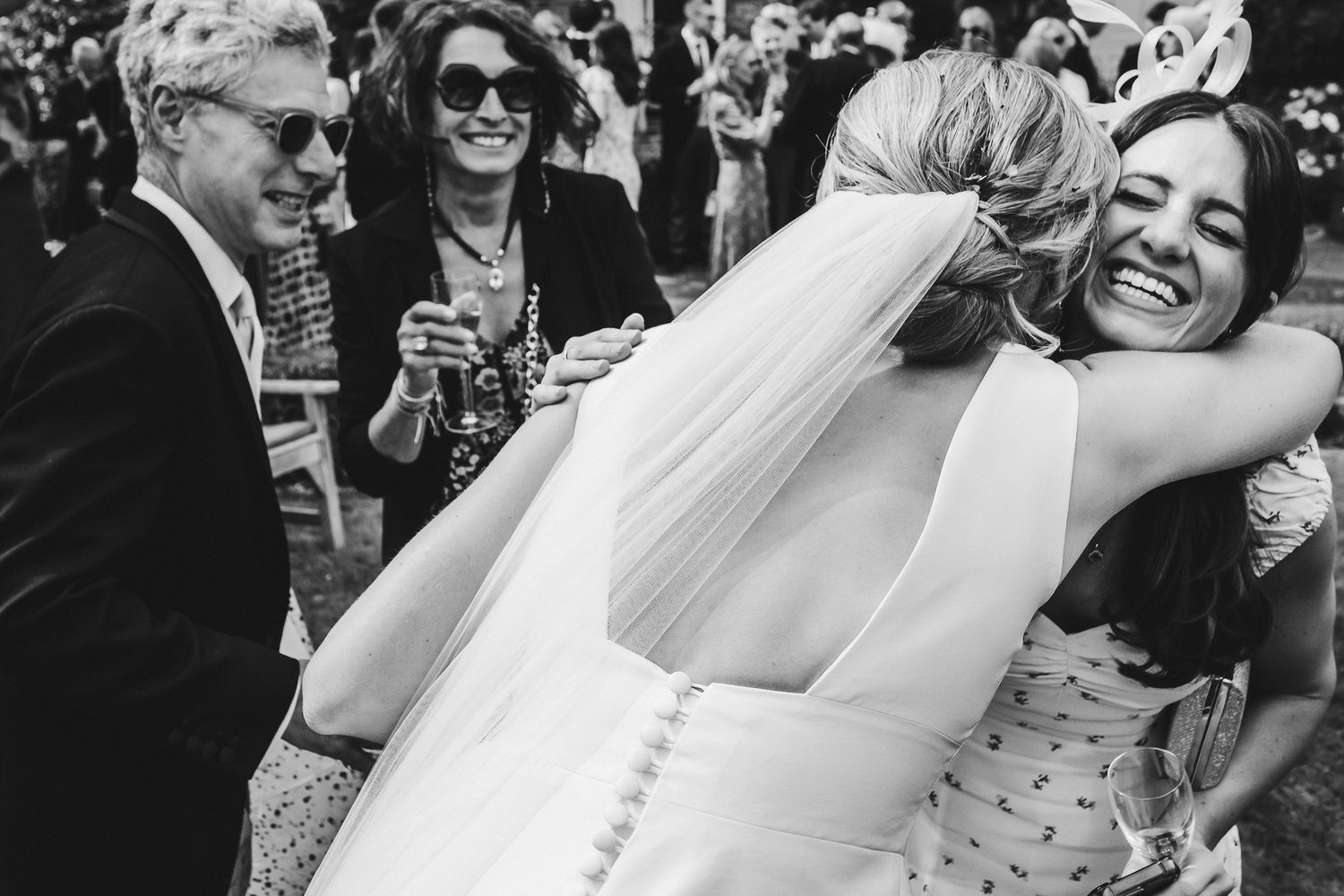 Wedding party members share joyful moments and laughter during outdoor celebrations.