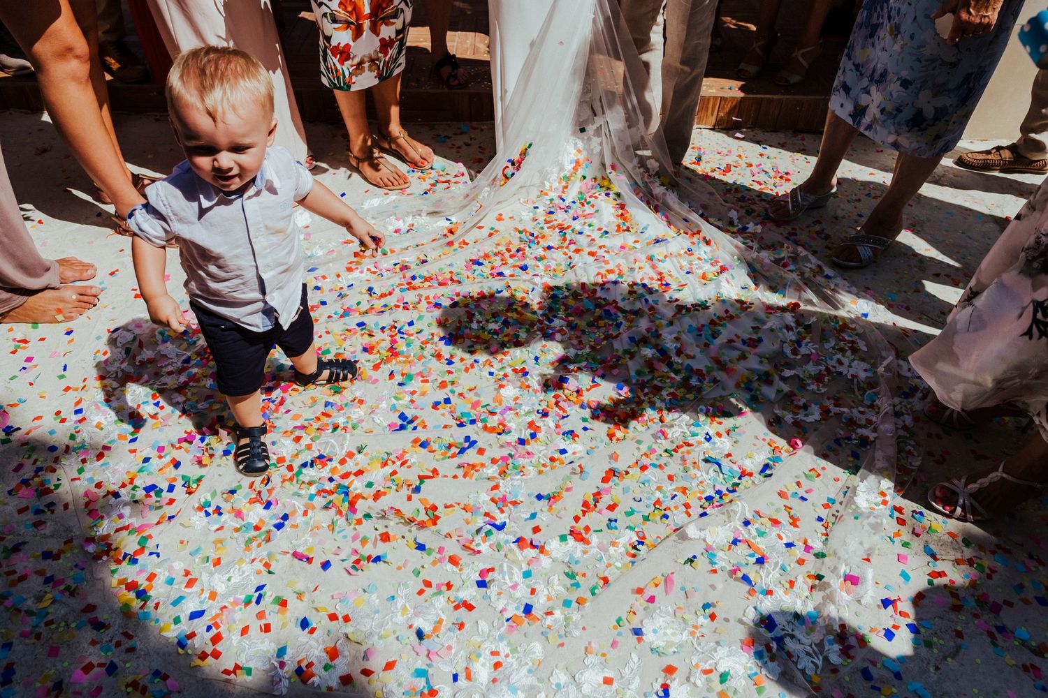 Colorful confetti scattered on the ground during wedding festivities.
