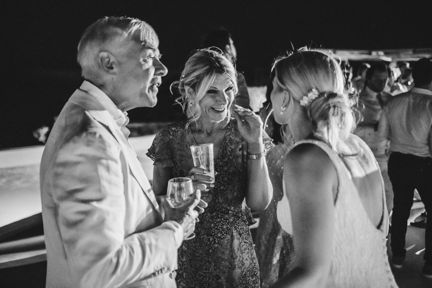 A romantic black and white composition shows a couple dancing together at their wedding reception.