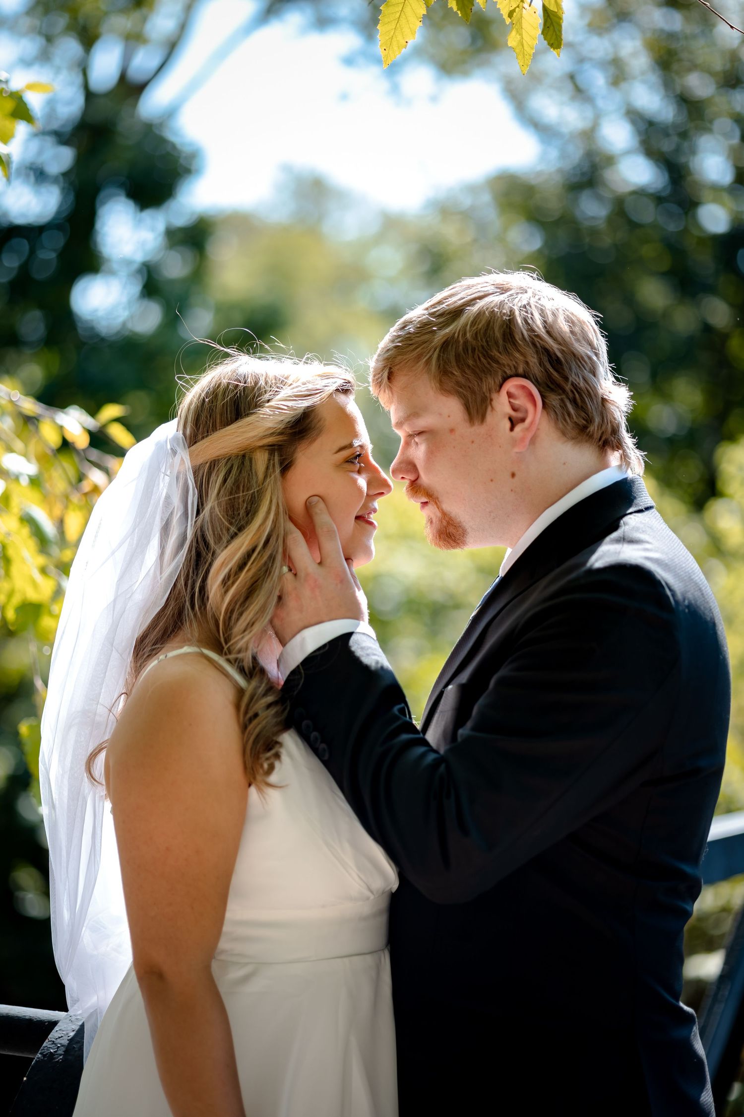 A romantic wedding moment captured in a series of four photos showing the couple sharing their first kiss outdoors.