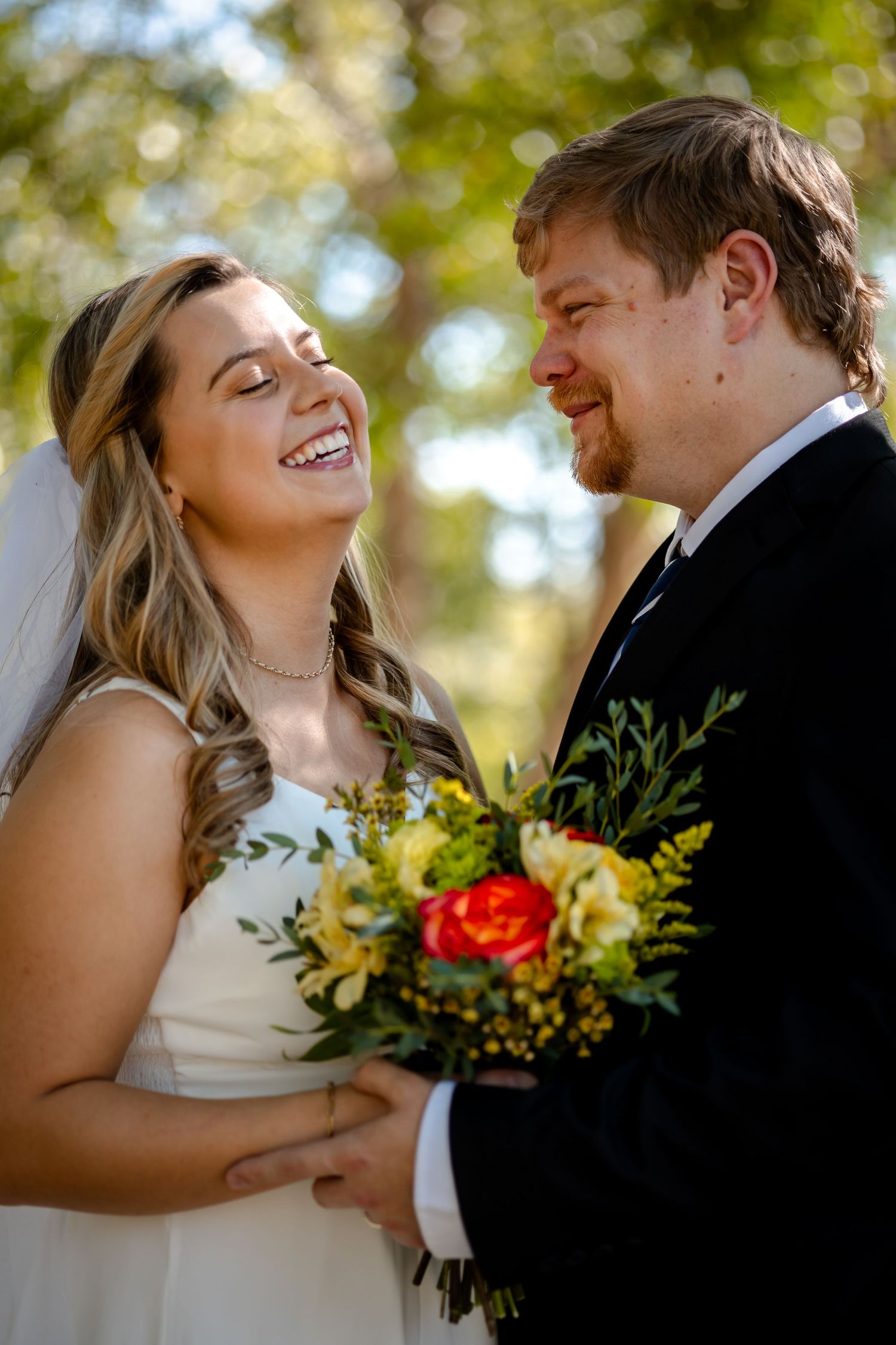 Romantic wedding couple shares intimate moments in a series of candid outdoor portraits with autumn foliage.