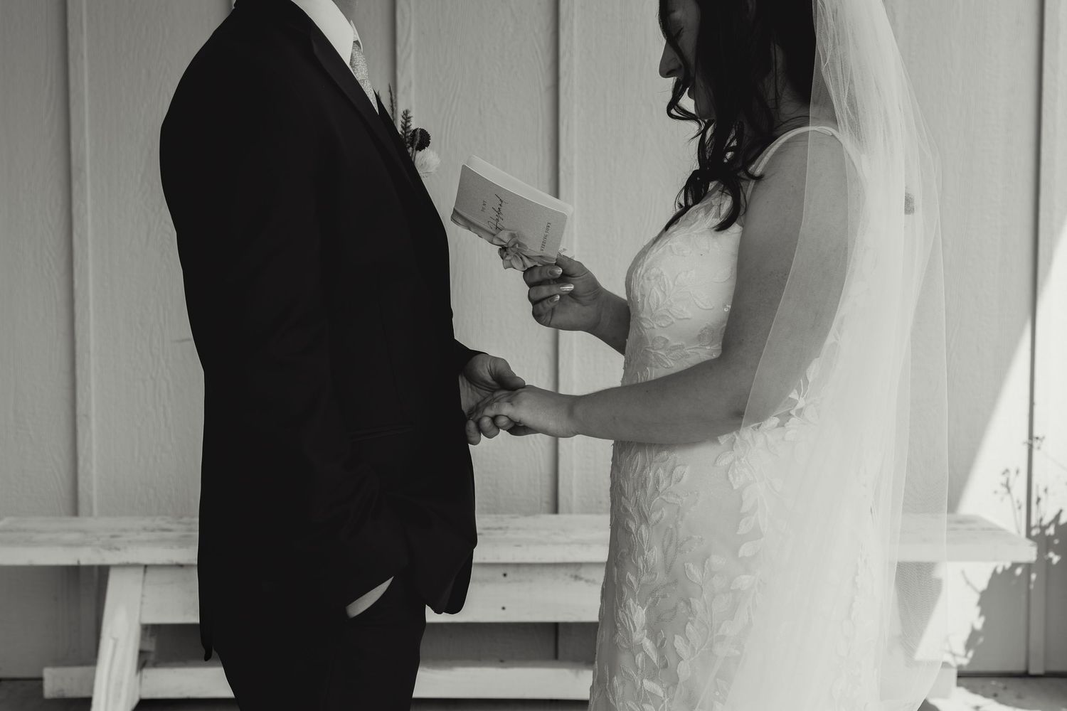 Bride and groom share a sweet moment while cutting their wedding cake together during the reception.
