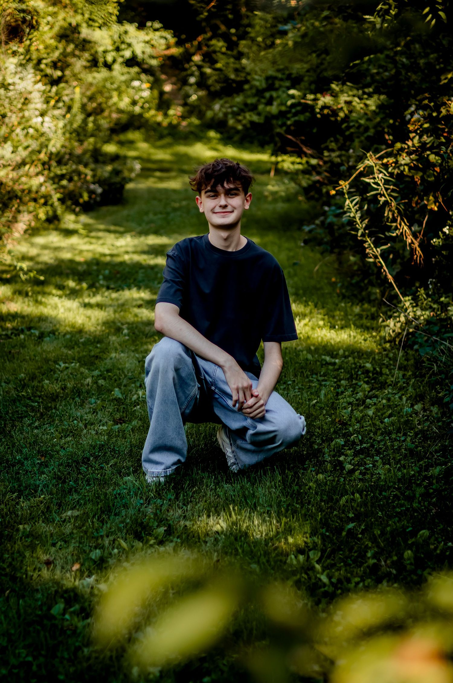 Natural outdoor portraits in dappled sunlight with casual attire.