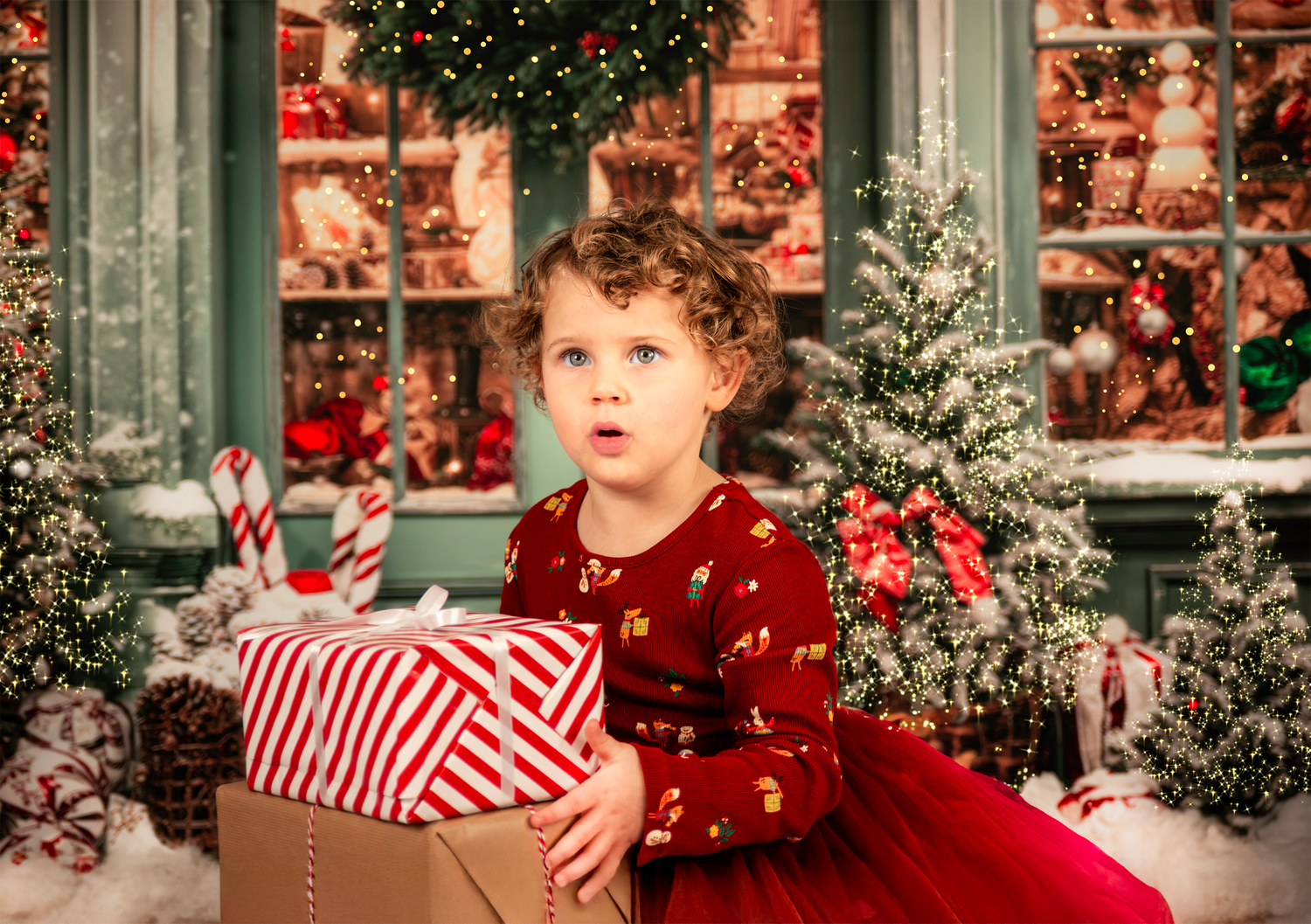 Christmas themed studio with decorated trees, candy canes, and red and white decor creating a magical winter atmosphere.