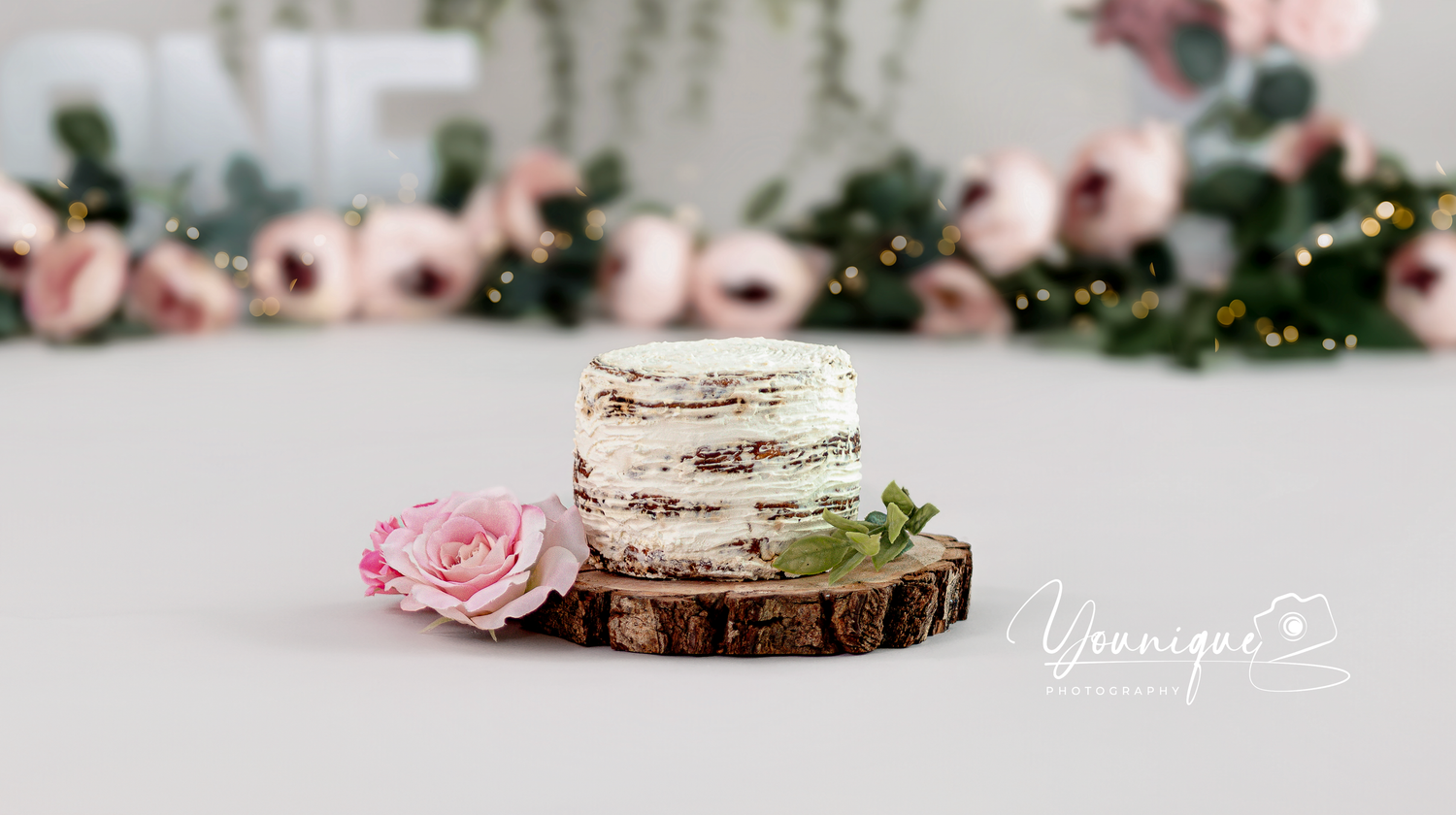 Pink roses and rustic wooden decor create an elegant table setting with romantic wedding details.