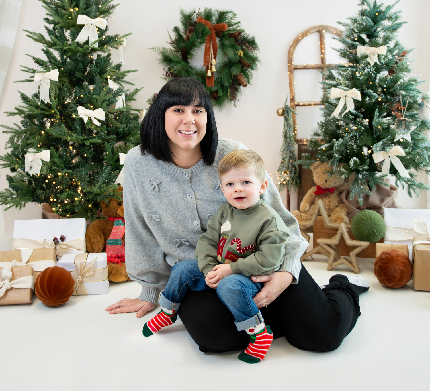 A holiday collage showing people sitting on a white floor with Christmas decor and greenery in the background.
