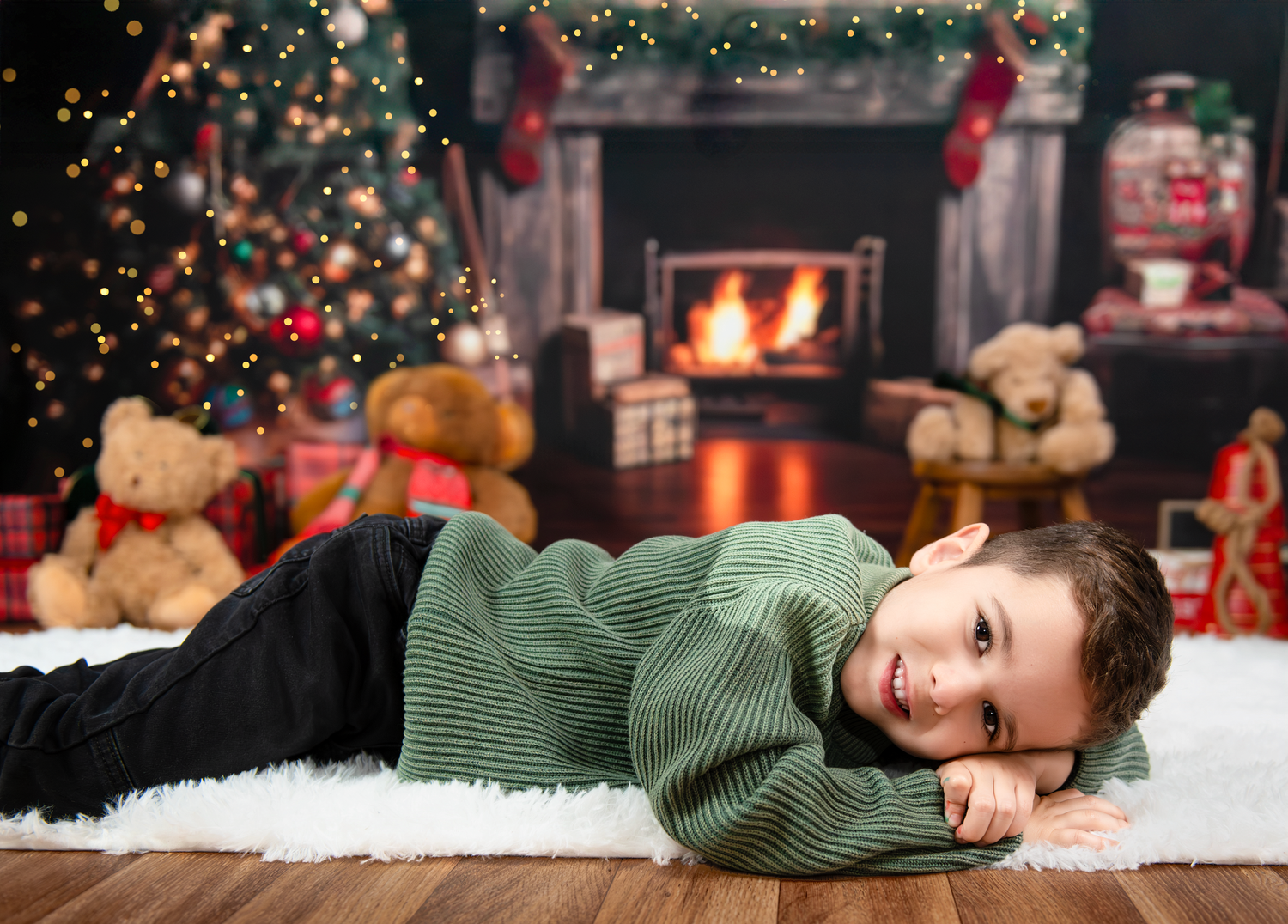 Cozy Christmas scene with a decorated tree, fireplace, stuffed animals, and a green sweater by the warm fire.