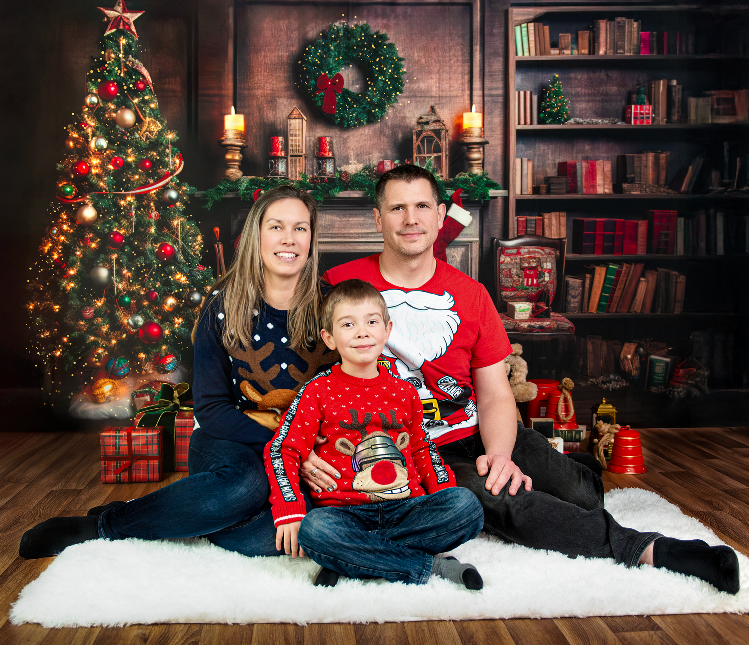 A festive Christmas photo series with people posing in front of a decorated tree and bookshelf in coordinating red outfits.