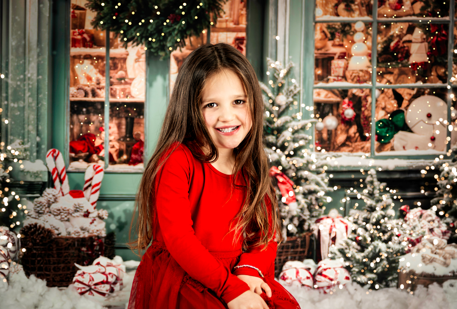 A festive holiday scene with red dress against a background of Christmas decorations, candy canes, and twinkling lights.