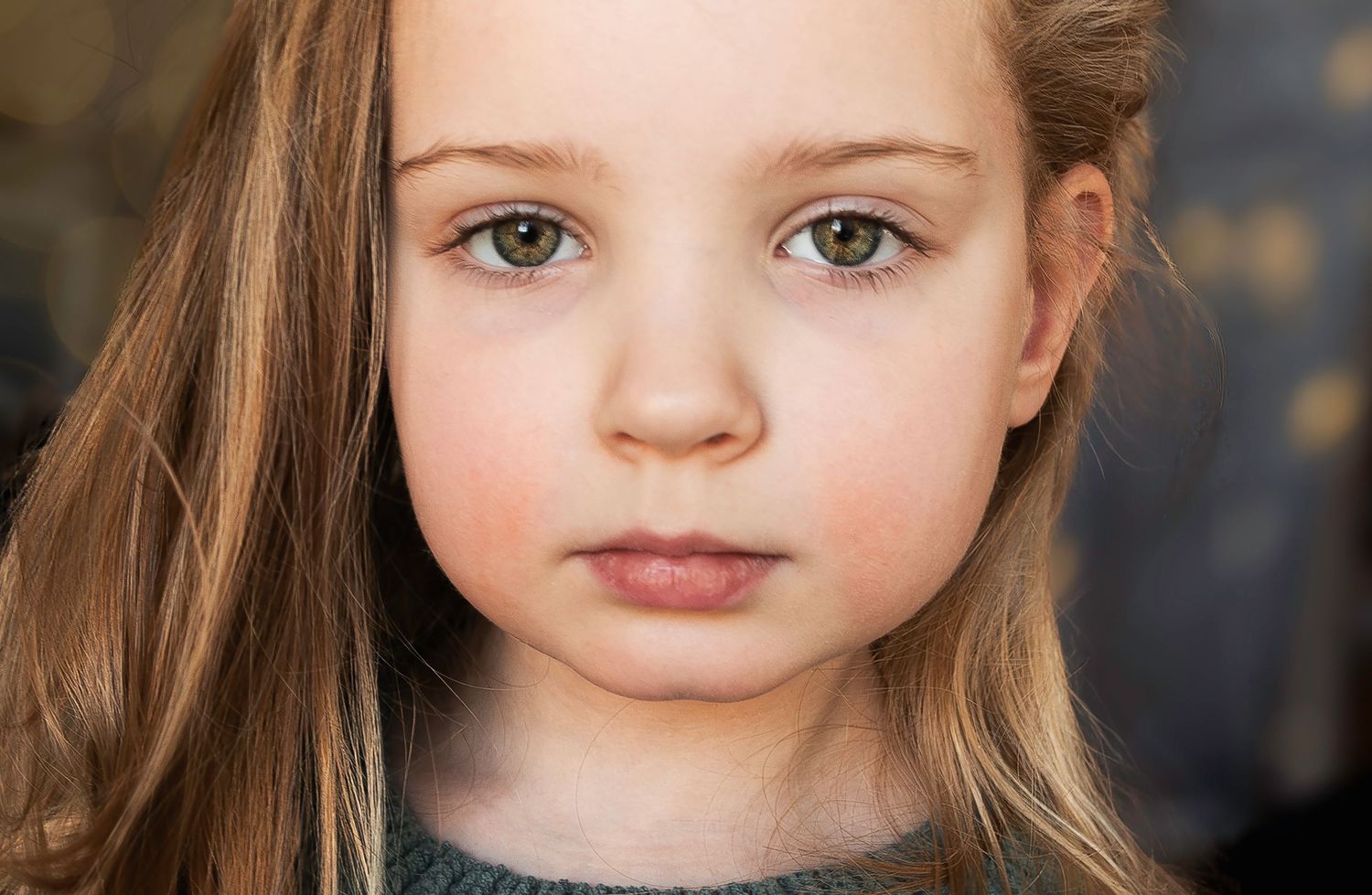 Close-up portrait series showing gentle expressions and natural lighting against a dark background.