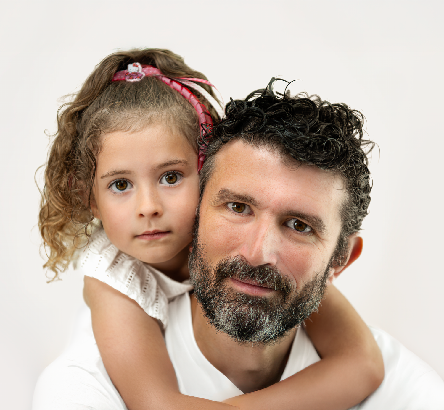 Intimate family portrait on white background showcasing close connection.