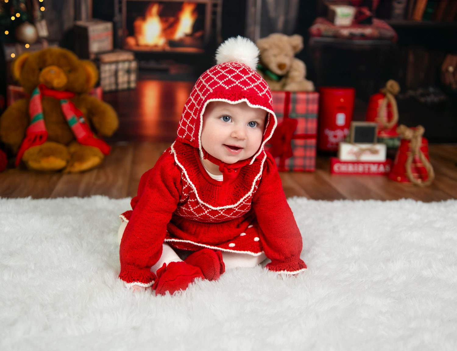 A series of photos showing a baby in red holiday clothing crawling and sitting on white snow with Christmas decorations.