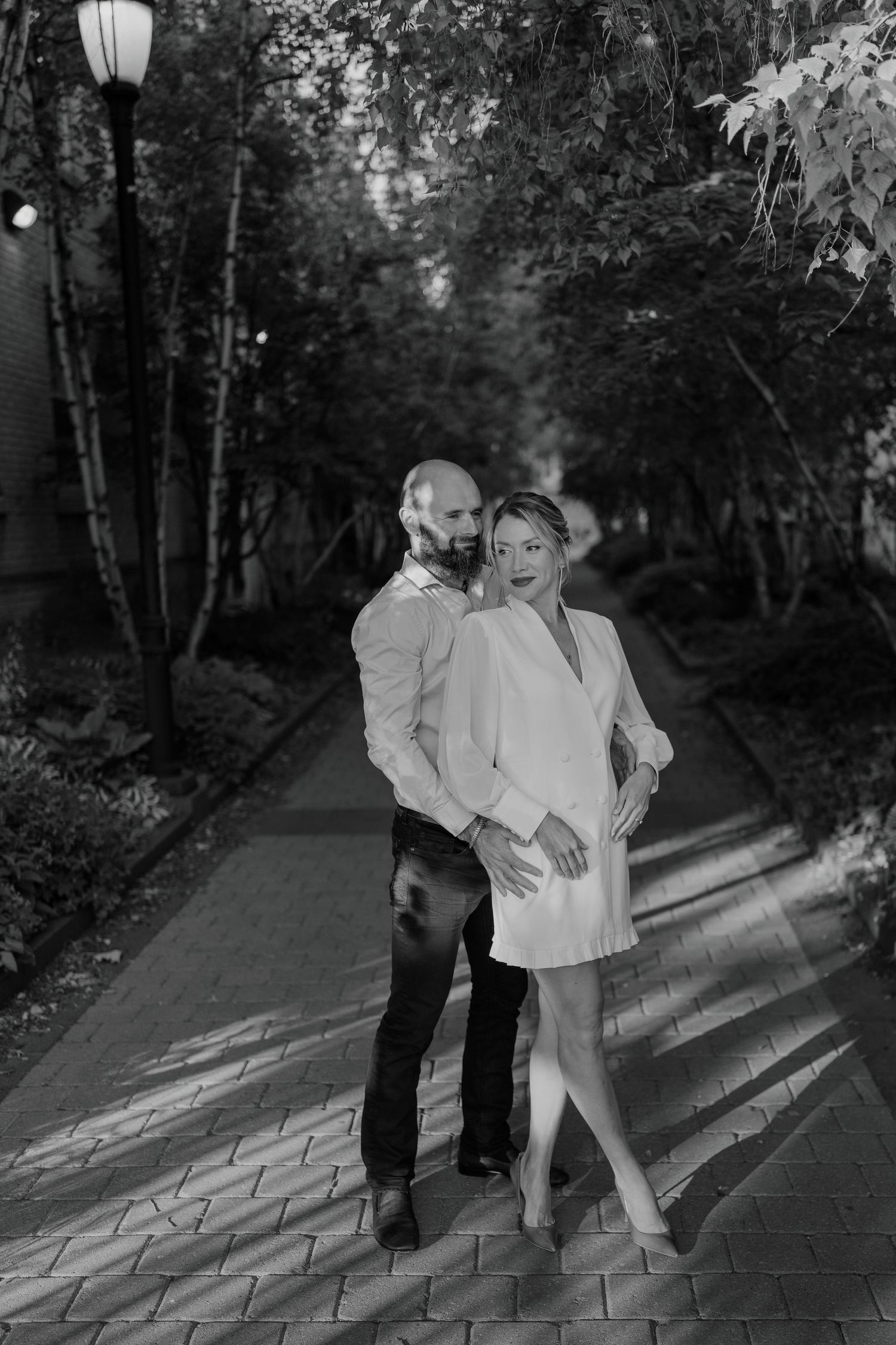 Black and white romantic couple portrait on wooded path