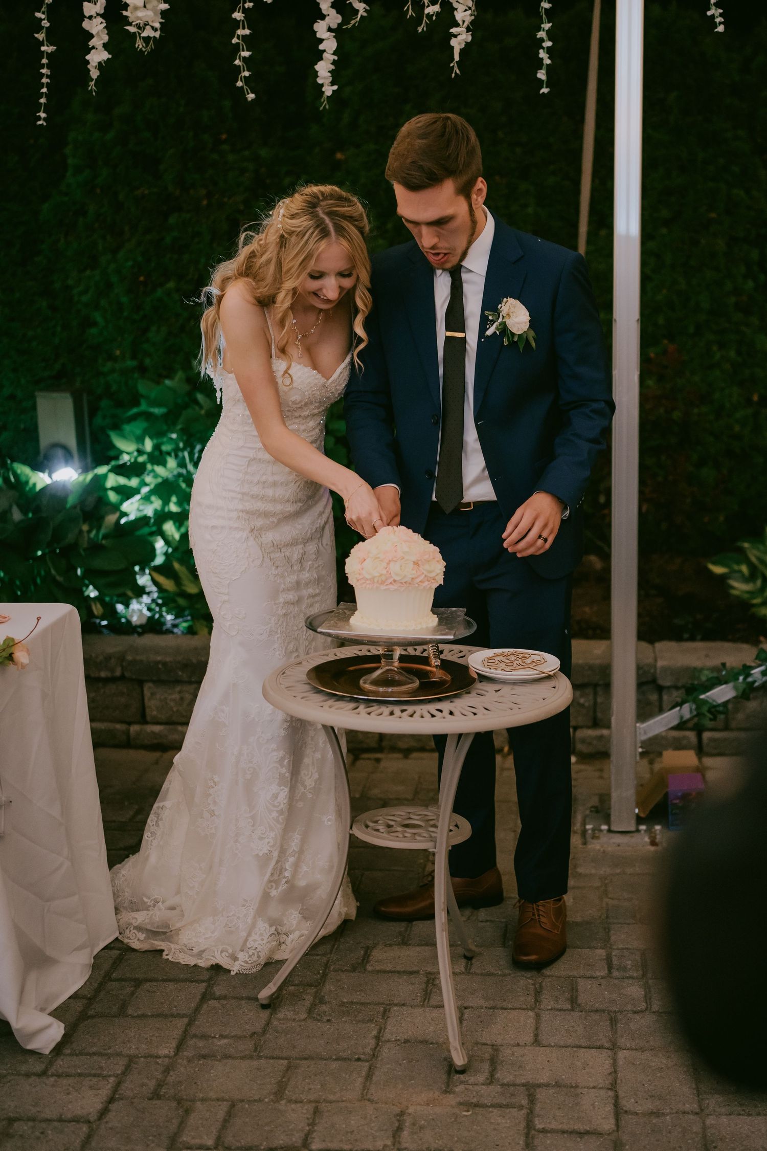 Bride and groom cutting wedding cake during reception