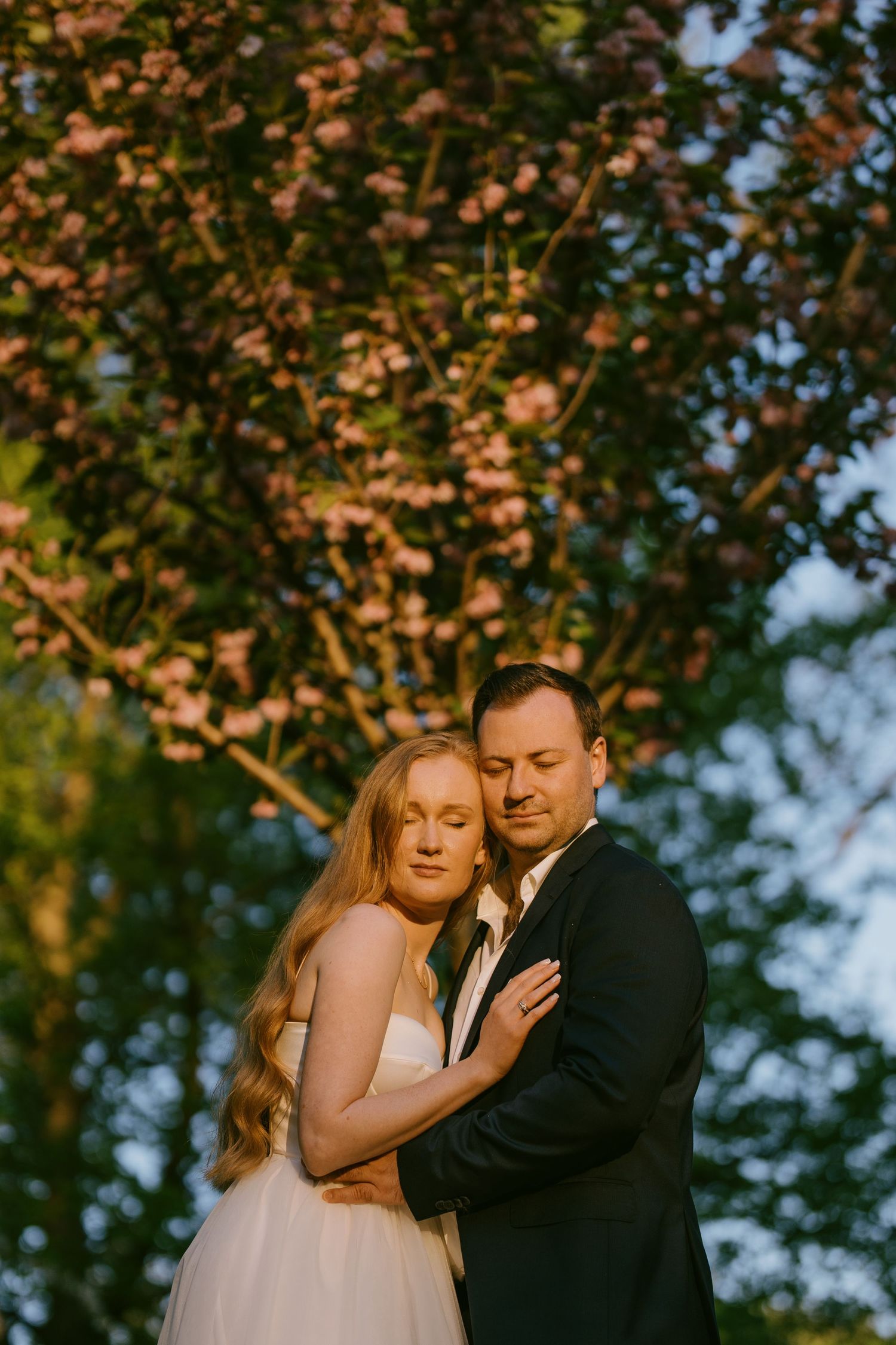 Romantic wedding portrait of bride and groom in warm golden-hour light in Toronto
