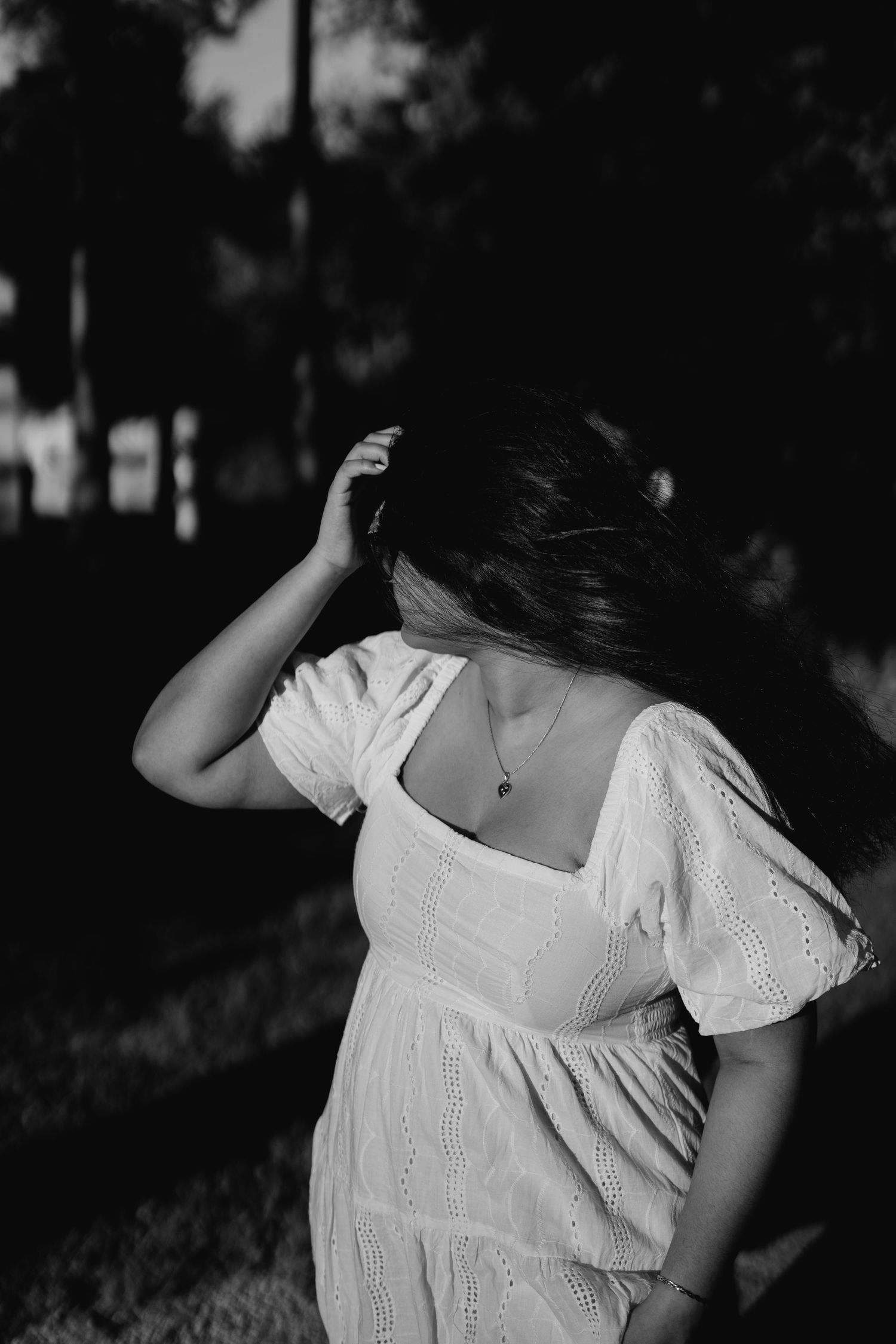 Artistic black and white portrait of woman in wind with soft expression