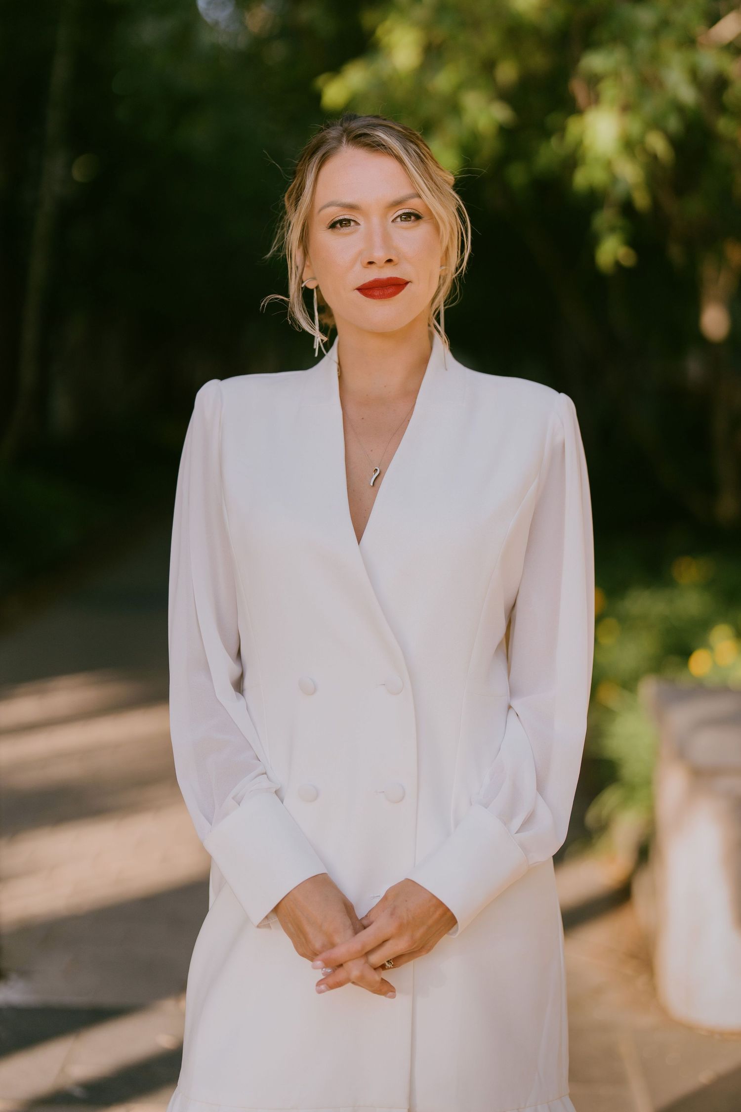 Modern editorial portrait of woman in a white blazer dress in soft natural light