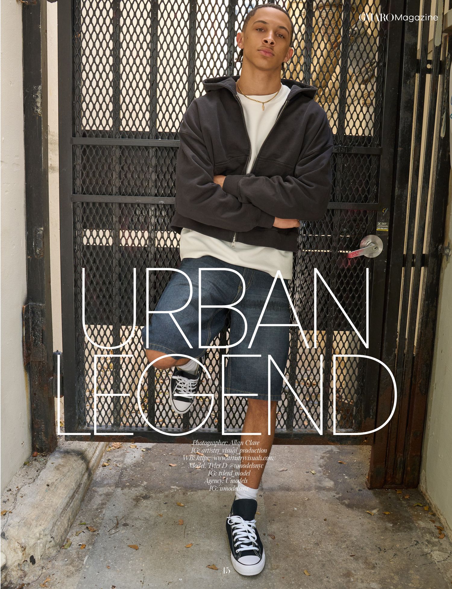 Young man in urban streetwear poses confidently against a metal gate for Urban Legend magazine feature.