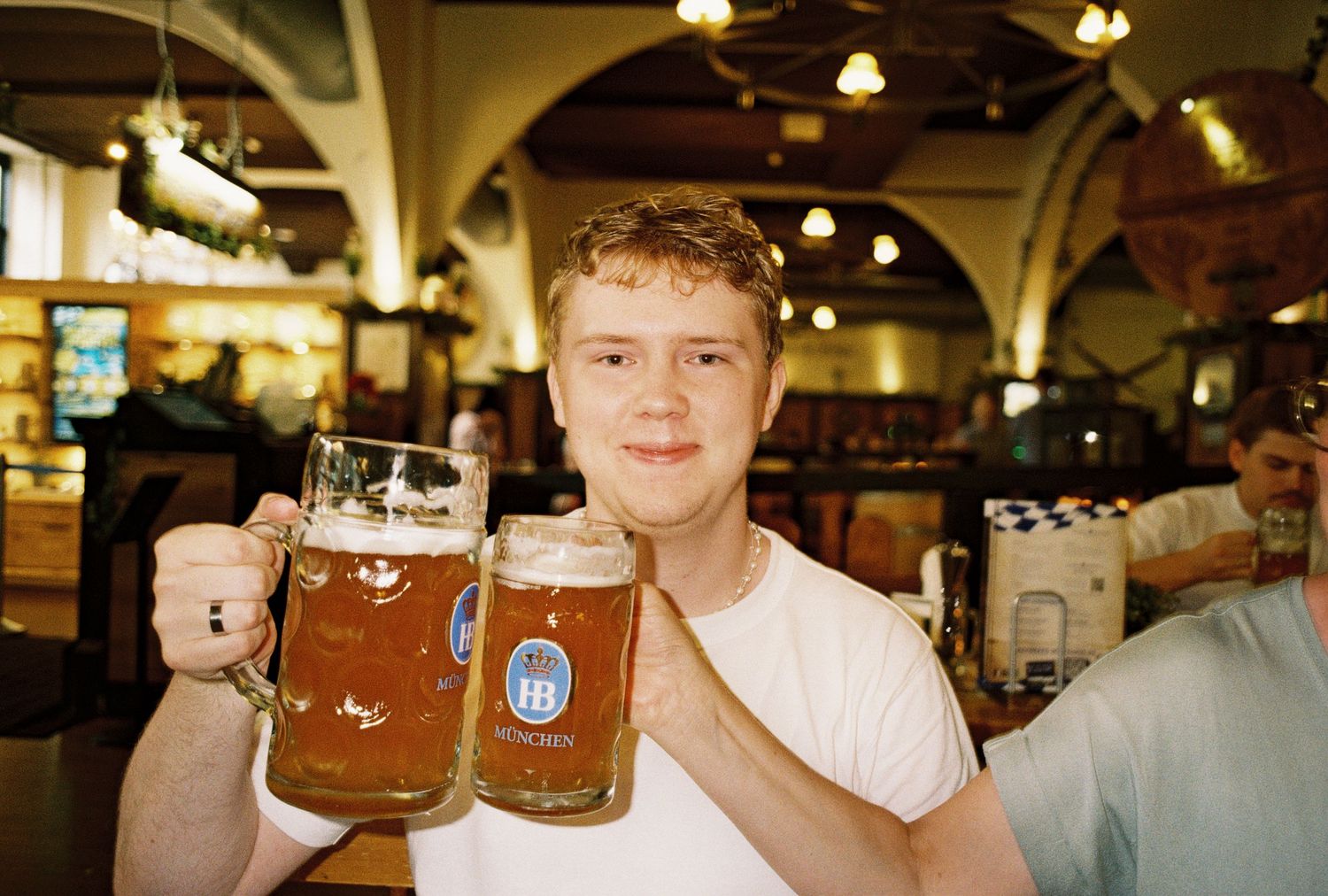 A collage of beer steins and people enjoying drinks at what appears to be a German beer hall or tavern.