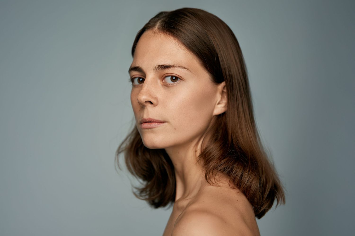 Portrait series against grey background showing contemplative expressions.