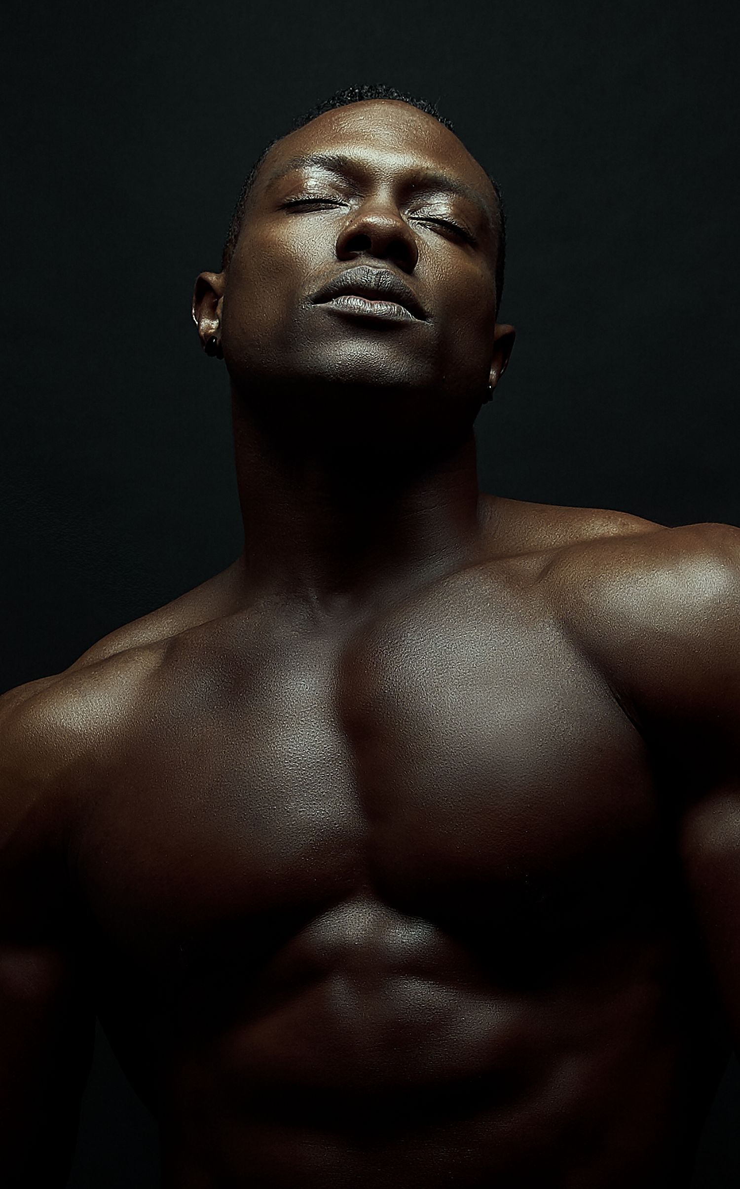 Artistic close-up portraits with dramatic shadows on dark background.