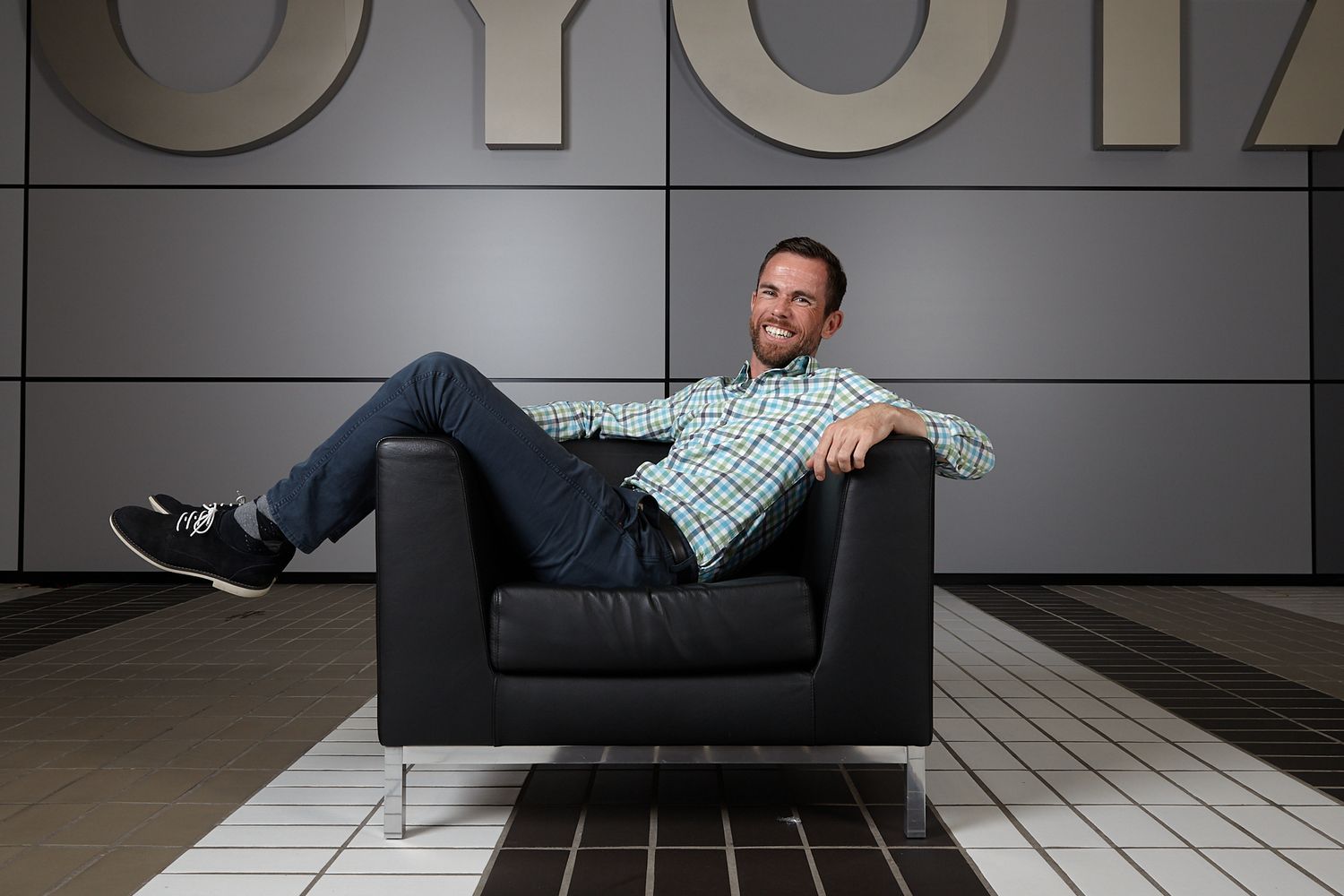 Series of creative portraits showing a person lying on a black couch in different poses.