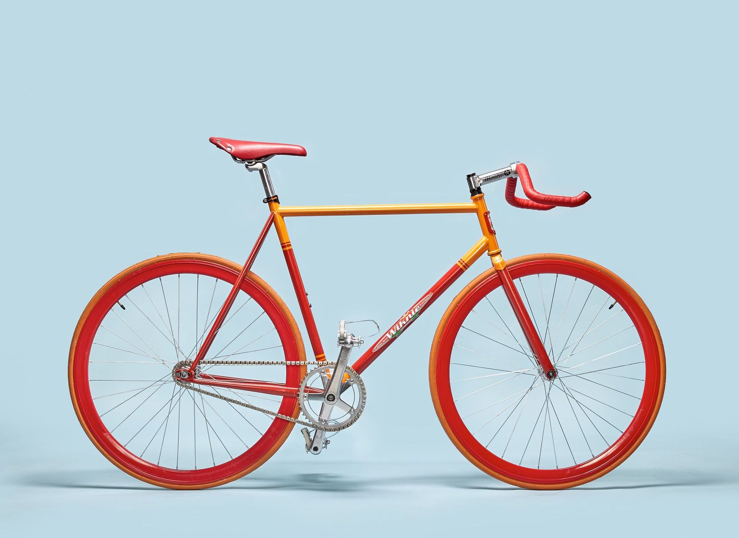 Minimalist red bicycles displayed in sequence against a light blue background.