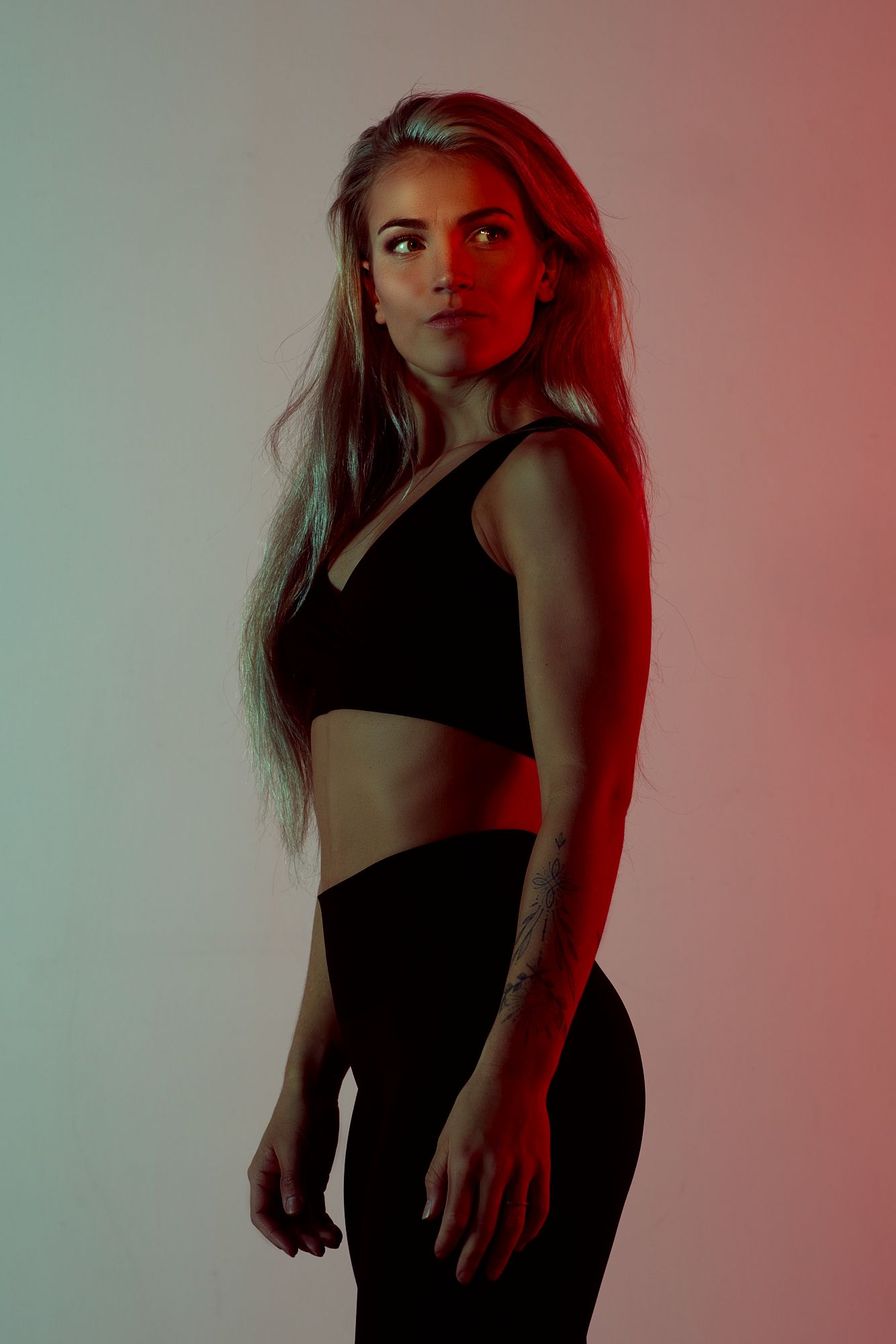 Artistic portrait series in red lighting showing dramatic poses against a dark background.
