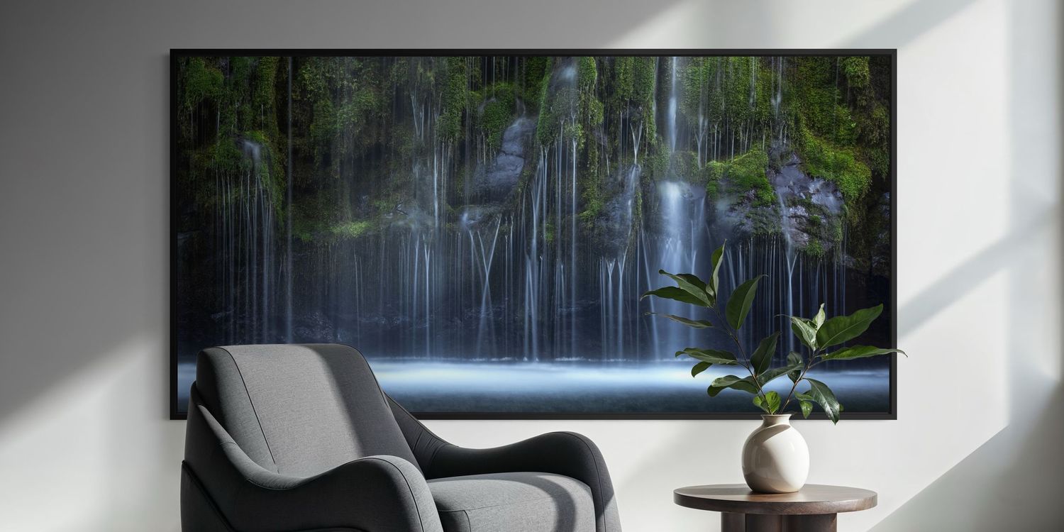 An elegant modern living room with a cascading waterfall photograph and minimalist white and gray interior design elements.