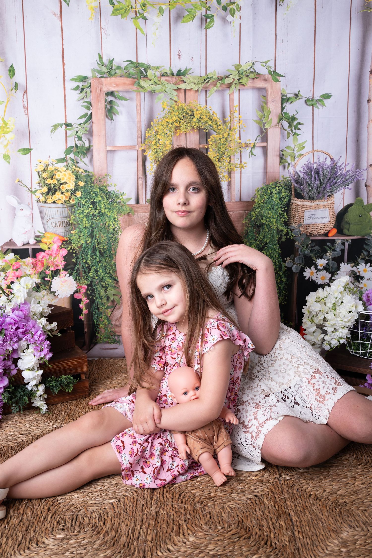Lifestyle photography session with floral decorations and rustic backdrop.