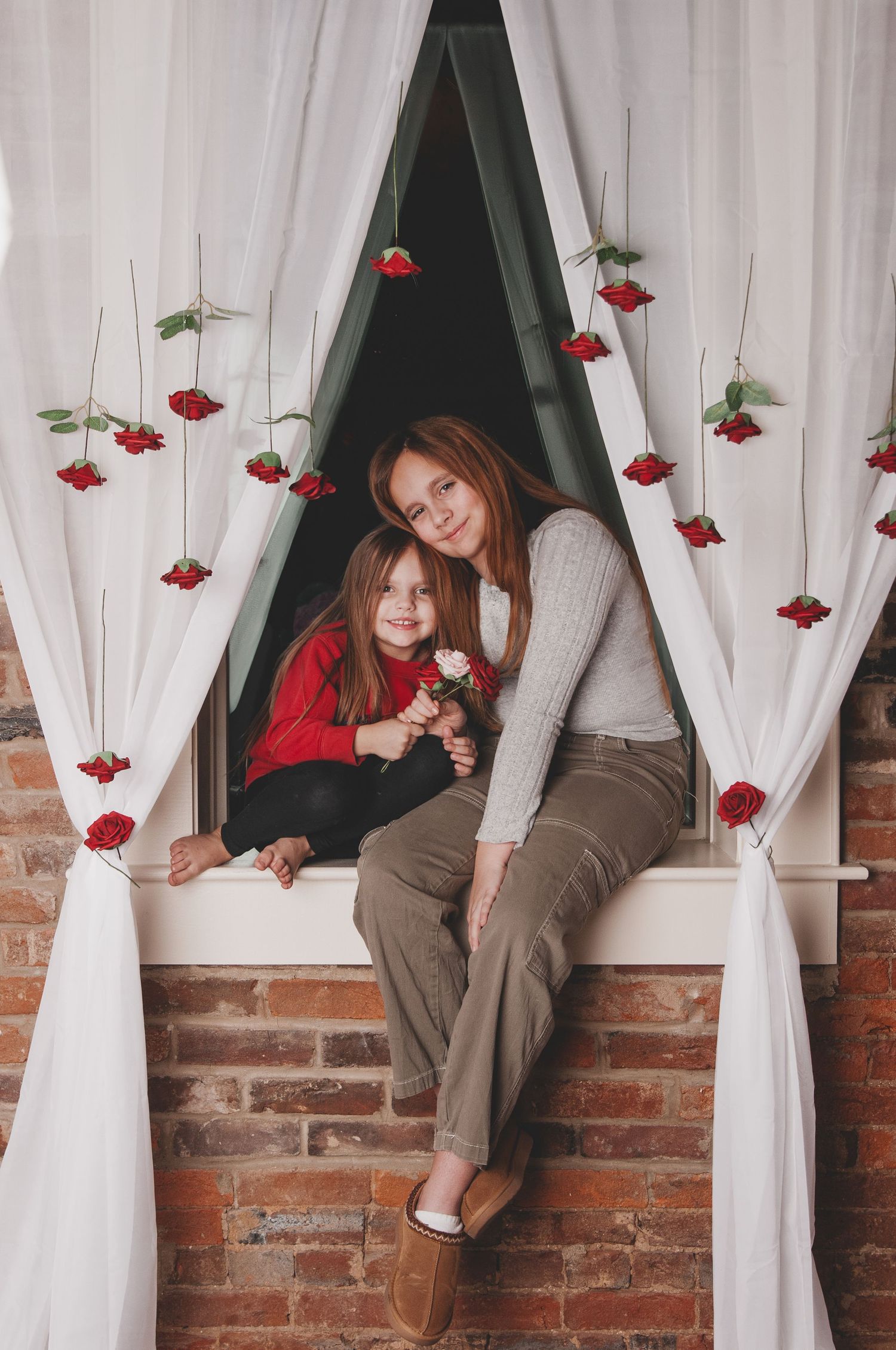A series of artistic photos showing someone sitting in a window frame with red roses and white curtains.