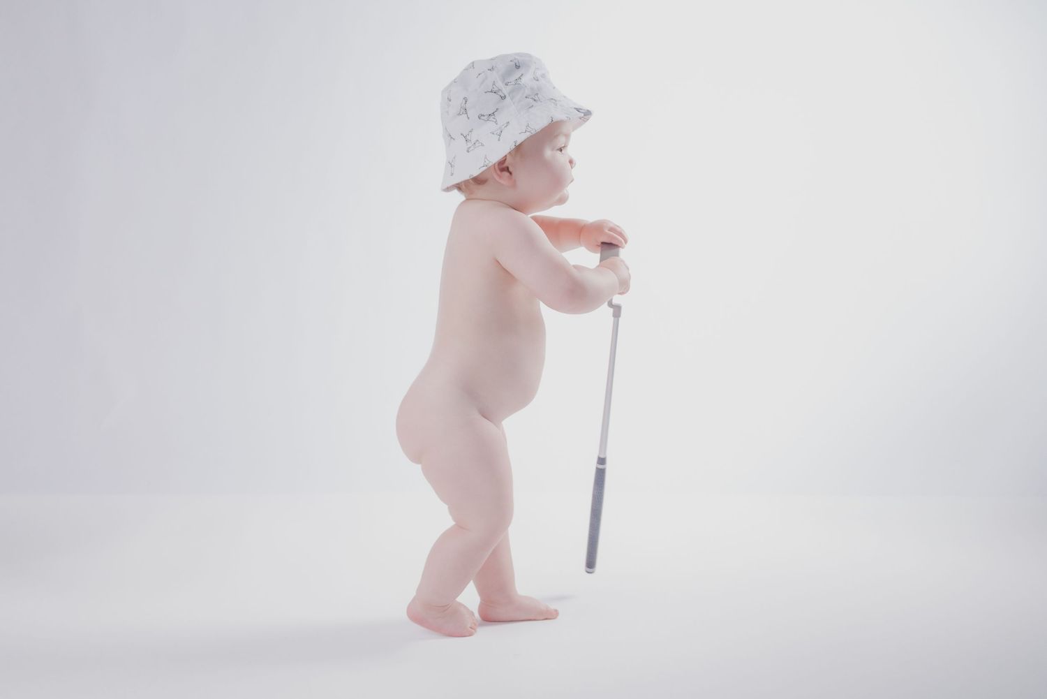 Minimalist baby milestone photos showing infant walking with white background. golf; bowling green KY; affordable milestone sessions