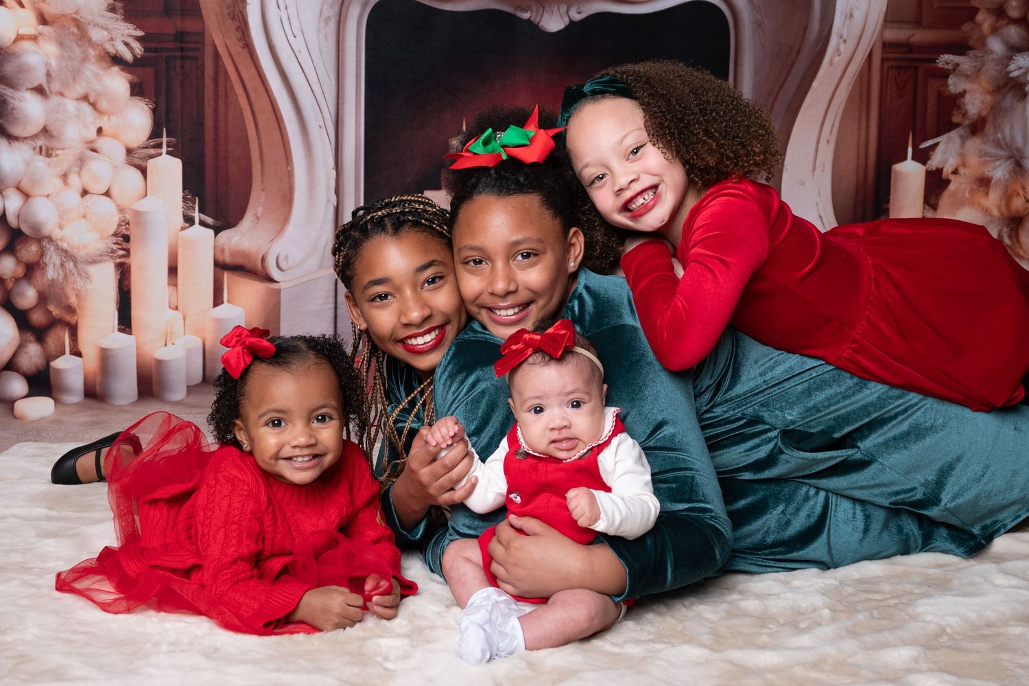 A group poses together in coordinating red and green holiday outfits for a festive Christmas photo shoot. Studio christmas franklin ky SOKY