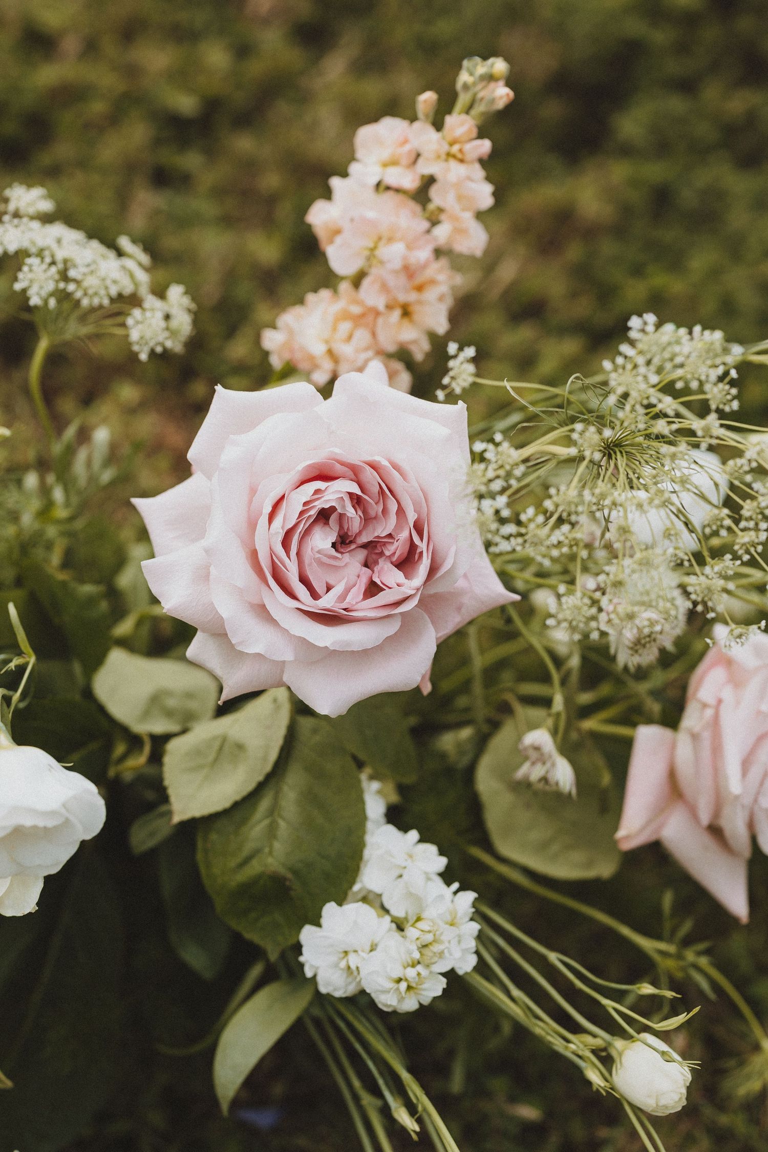 Elegant pink rose bouquet with white blooms and greenery, perfect for weddings or floral arrangements.