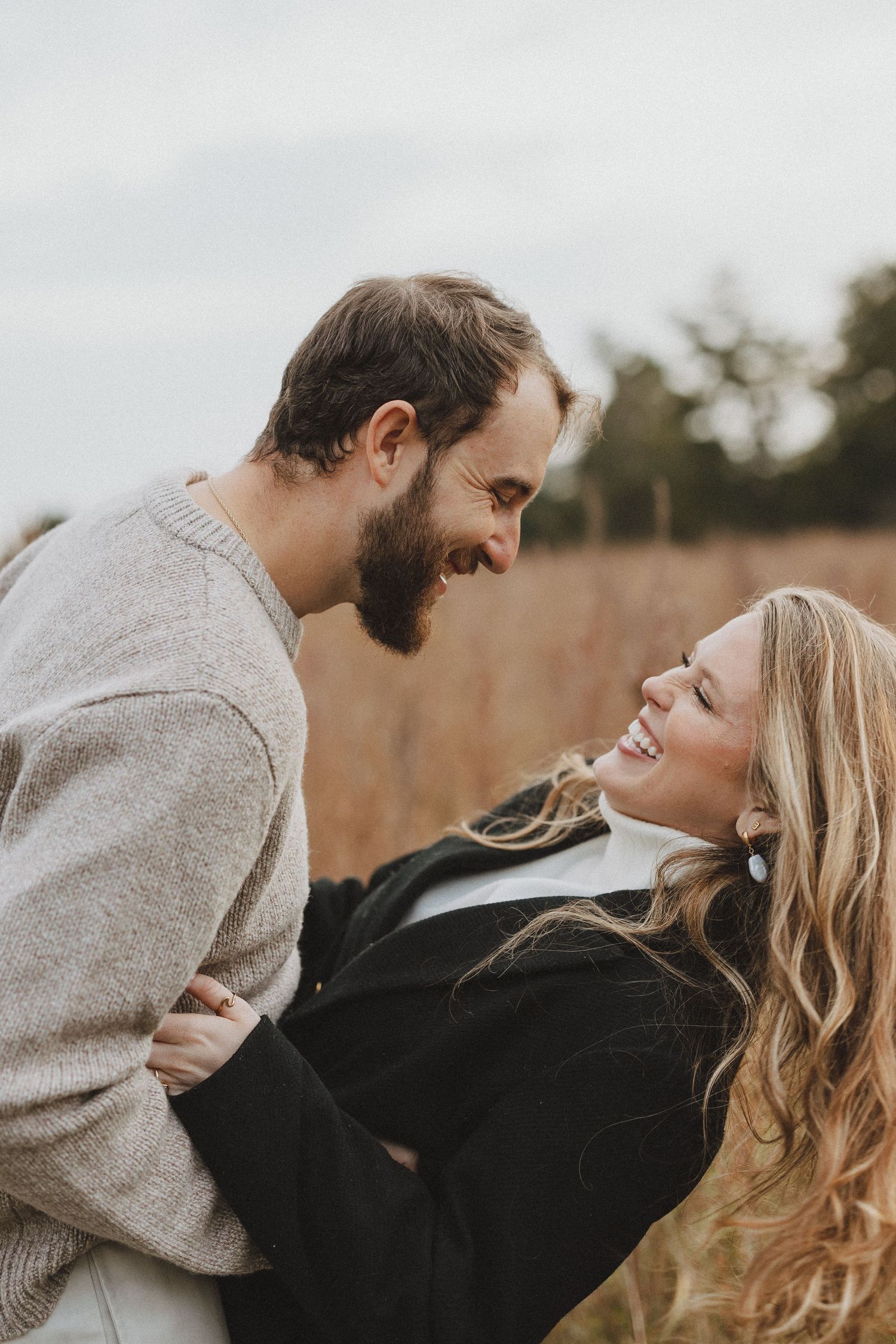 A romantic couple embraces and laughs together in a series of candid outdoor photos during golden hour.
